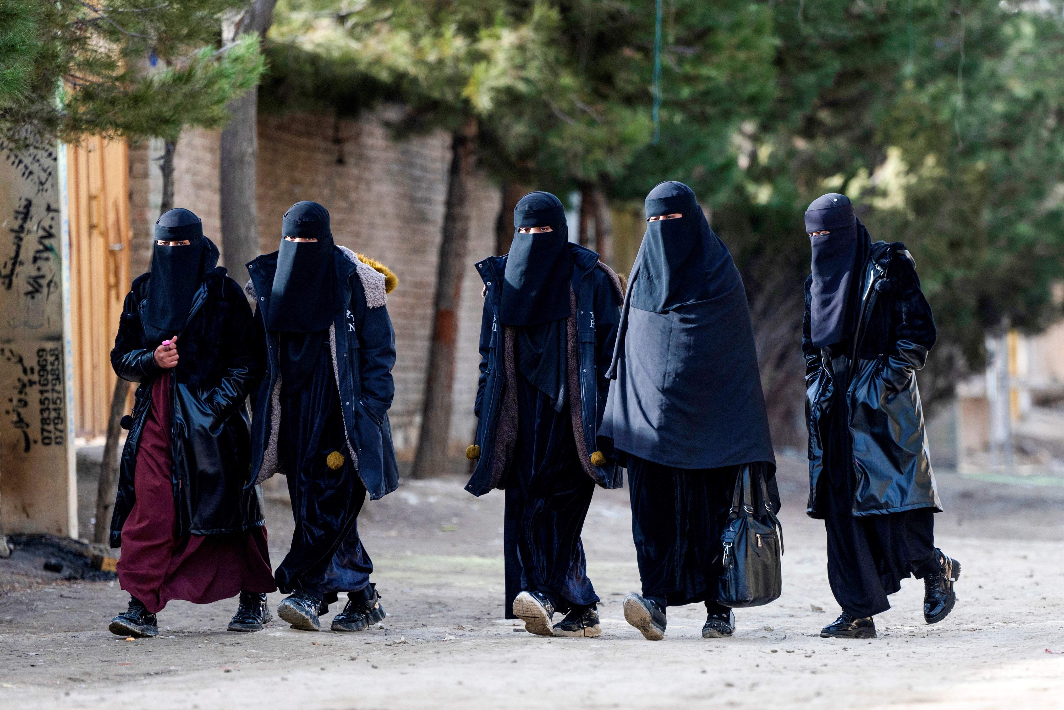 Afghan women walk on the outskirts of Kabul