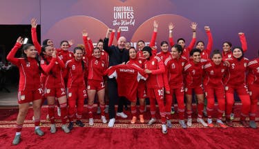 <p>Fifa chief Gianni Infantino poses with players of Afghan Women United</p>