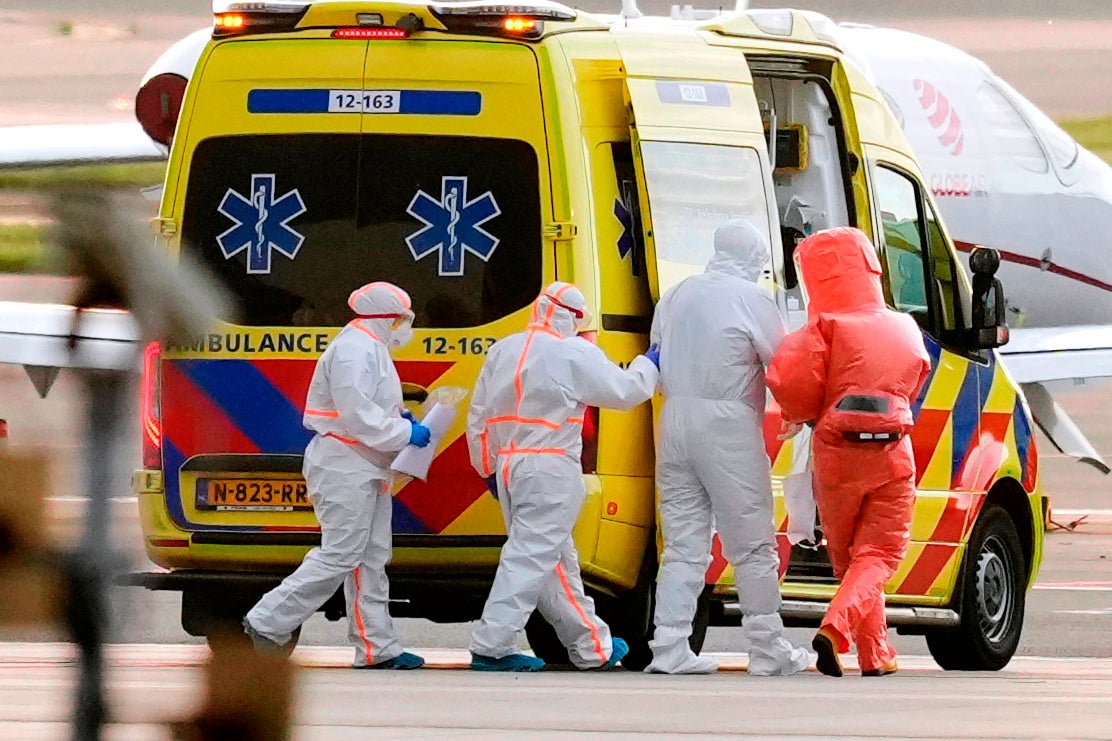 Medical personnel accompany a patient, second from the right, evacuated from the cruise ship MV Hondius with suspected hantavirus infection