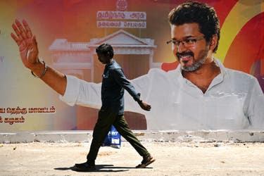 <p>A man walks past a poster hailing the election victory of Joseph Vijay Chandrasekhar in Chennai, Tamil Nadu, on 7 May 2026 </p>