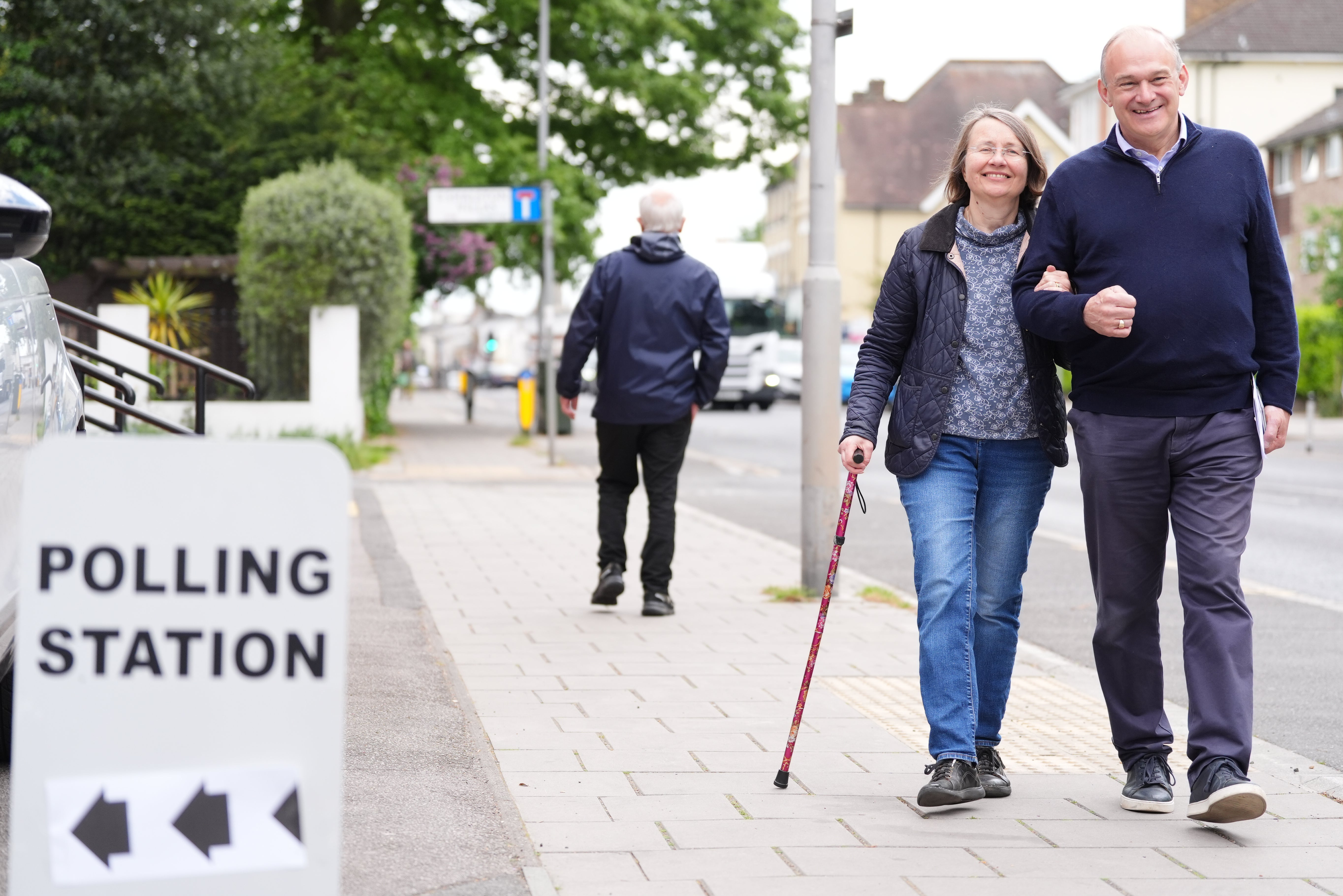 Liberal Democrat leader Sir Ed Davey and his wife Emily Davey arrive to cast their votes in Surbiton
