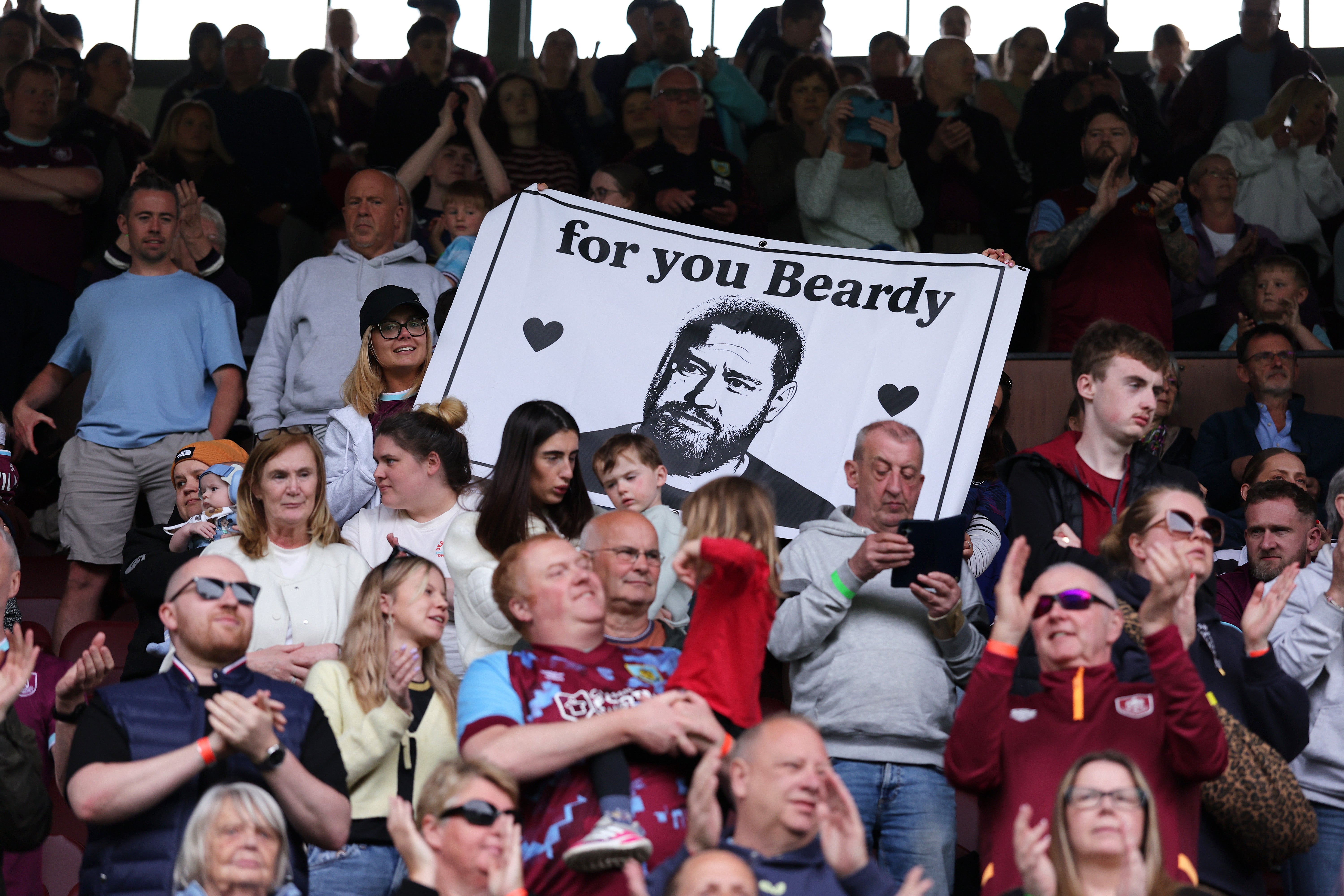 Burnley FC fans unfurl a banner in memory of Matt Beard during a match between Burnley and Stoke City in April