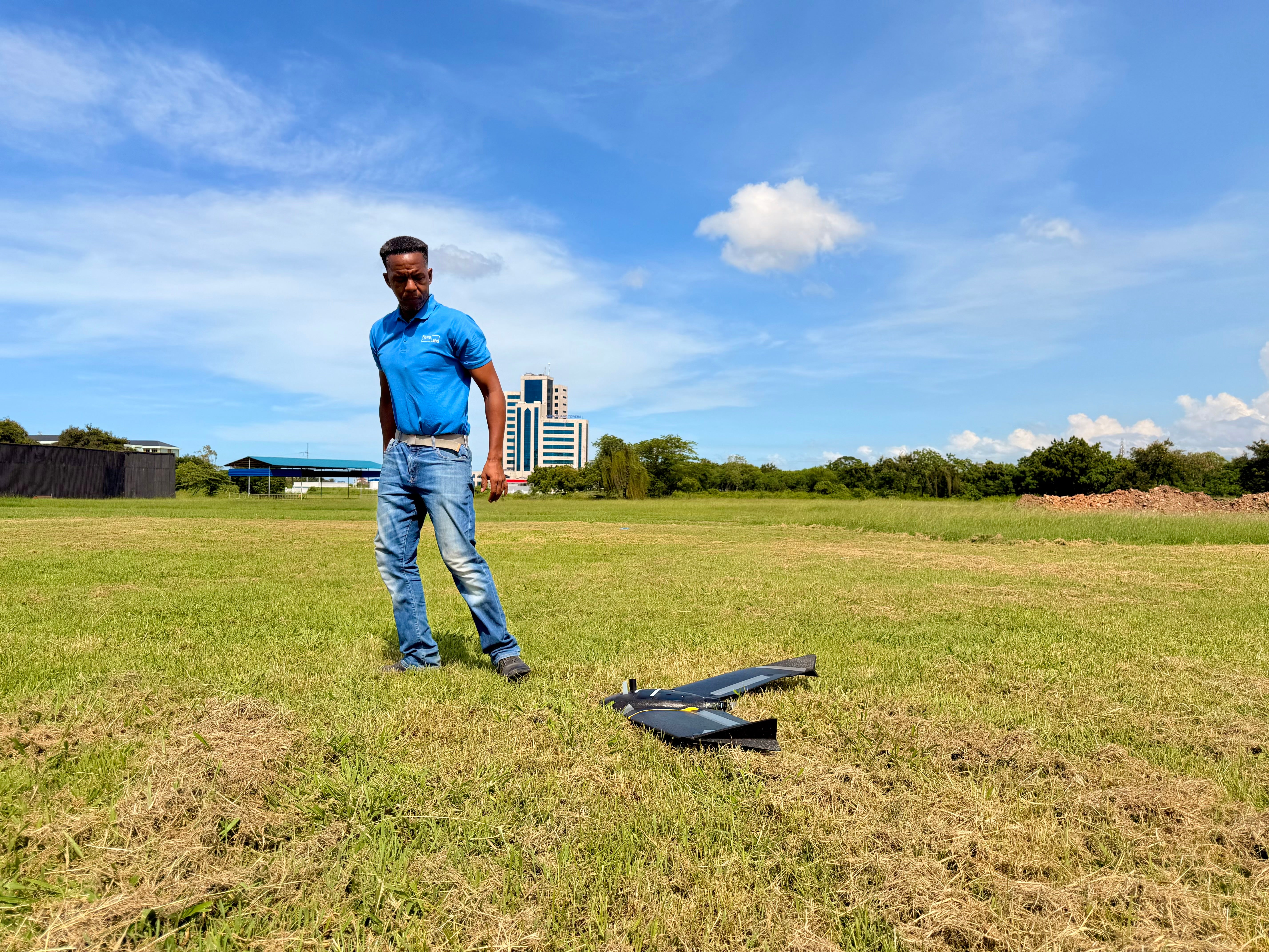 Leka Tingitana, the director of Tanzania Flying Labs, goes to collect his drone after it has mapped a one kilometer square area of Dar Es Salaam. Such drone mapping is a crucial monitoring tool as cases of the disease increase in the city during the climate crisis