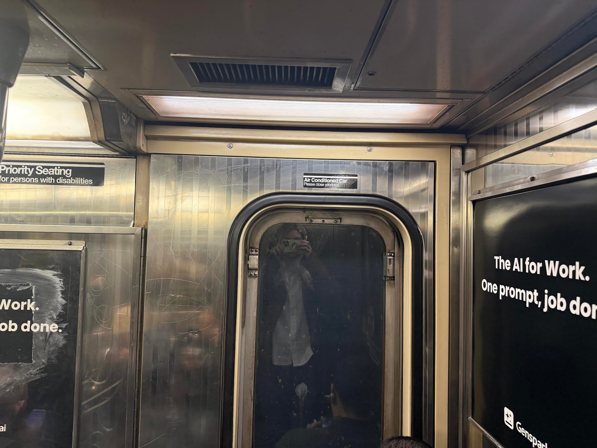 Julia Musto takes a selfie using the window of a New York City subway car