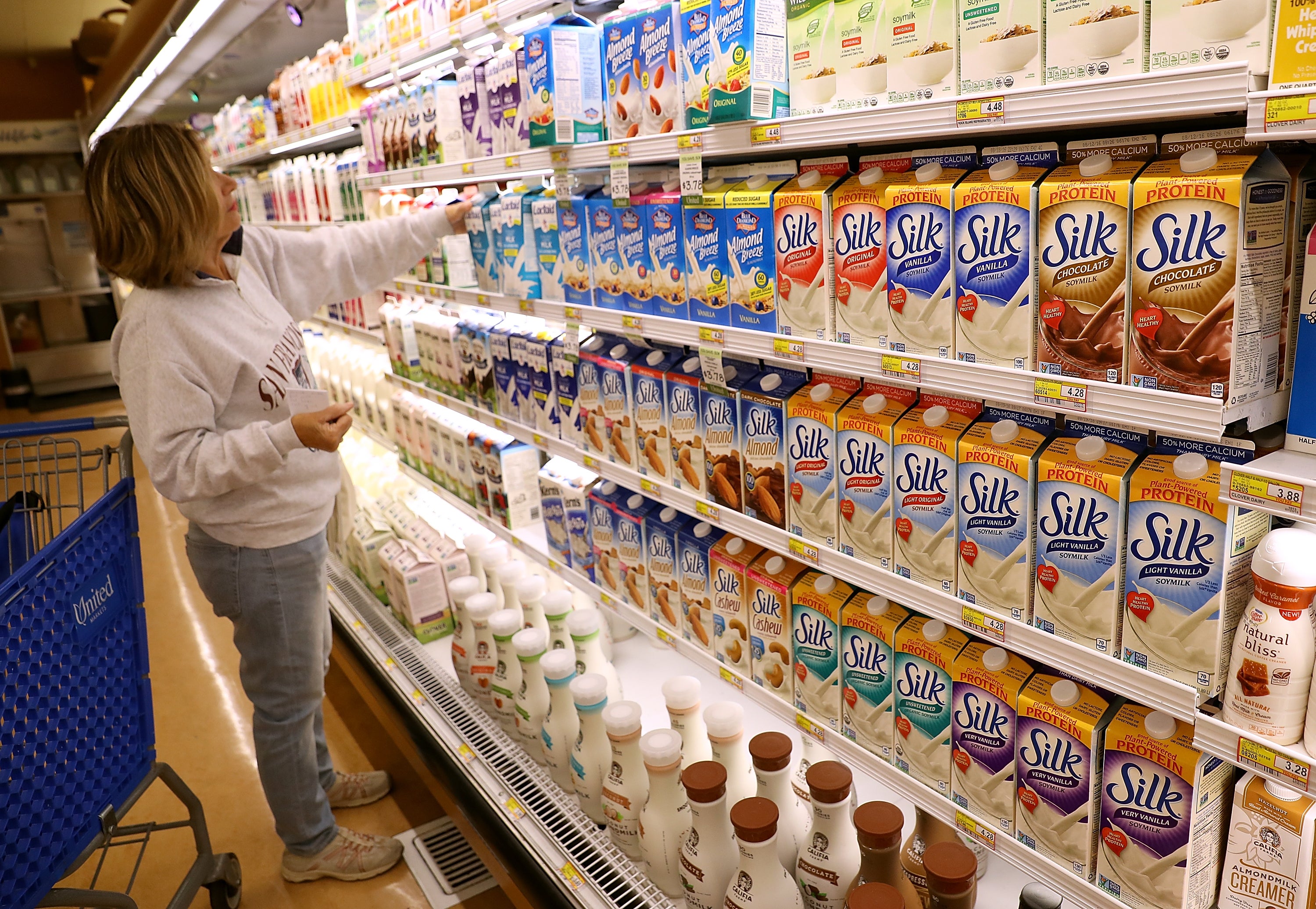 A woman shops for soy milk in Northern California. Getting enough vitamin B12 from soy milk and other products could help you make gains in the gym, a recent study found