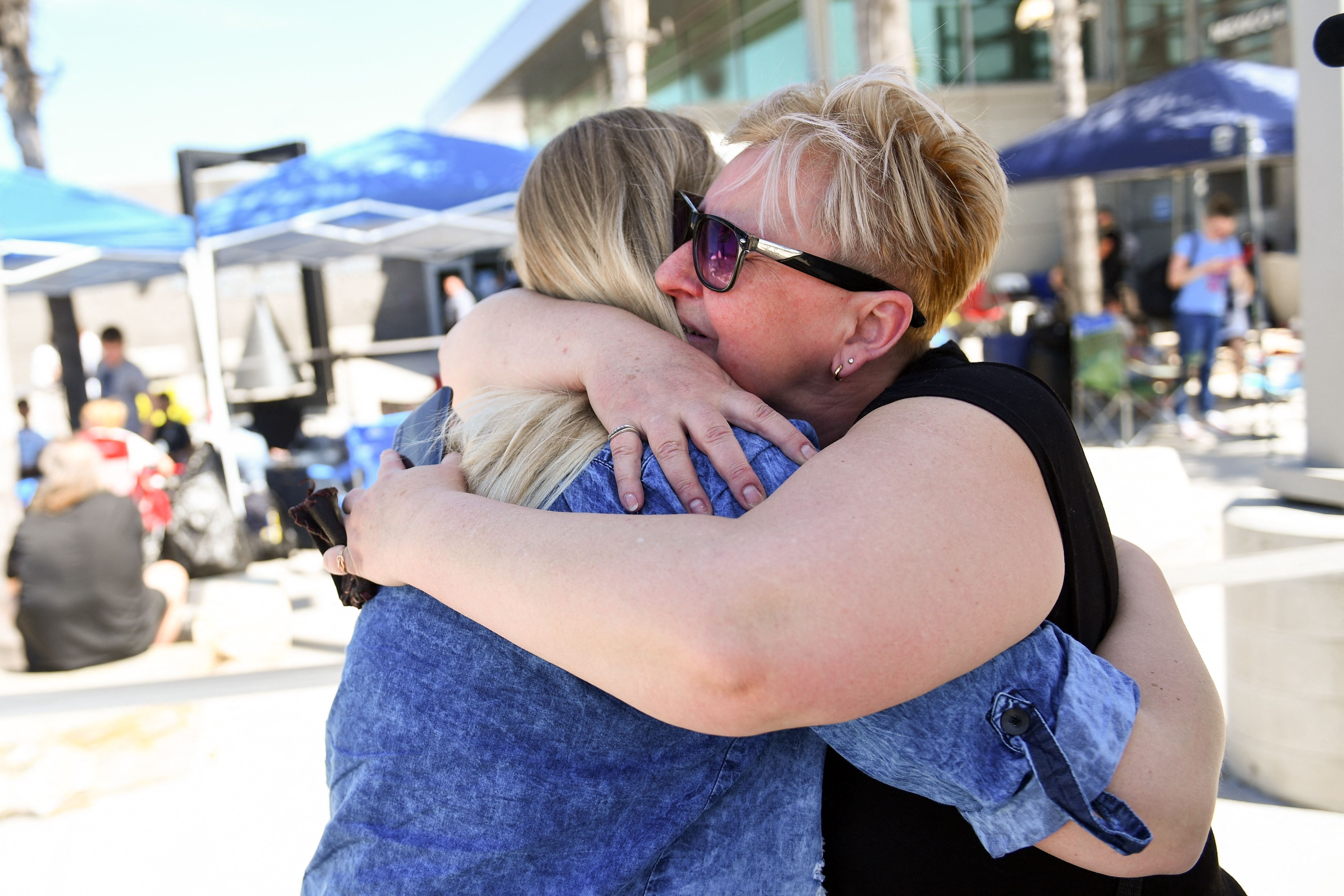 A mother hugs her daughter in San Ysidro, California, in April 2022. If your mother isn’t around this Mother’s Day, experts say a phone call or voicemail can help