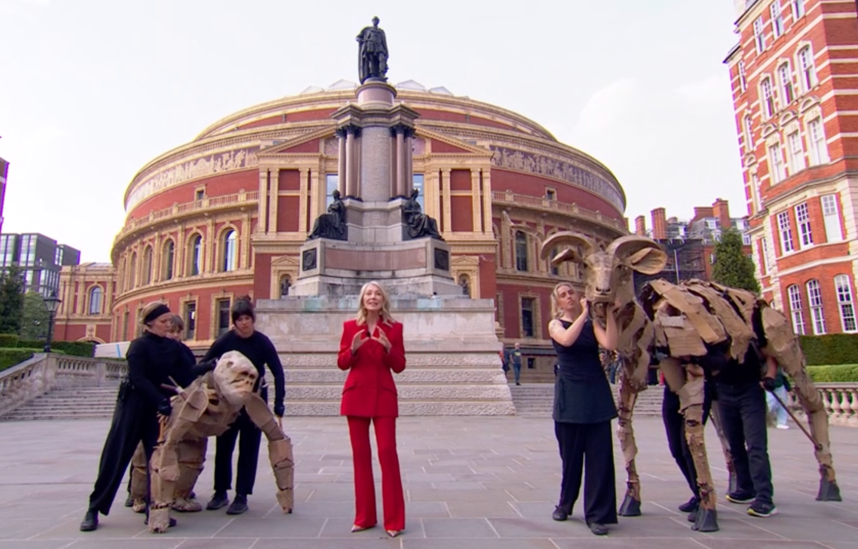 Kirsty Young stood awkwardly alongside two puppet animals outside the Royal Albert Hall
