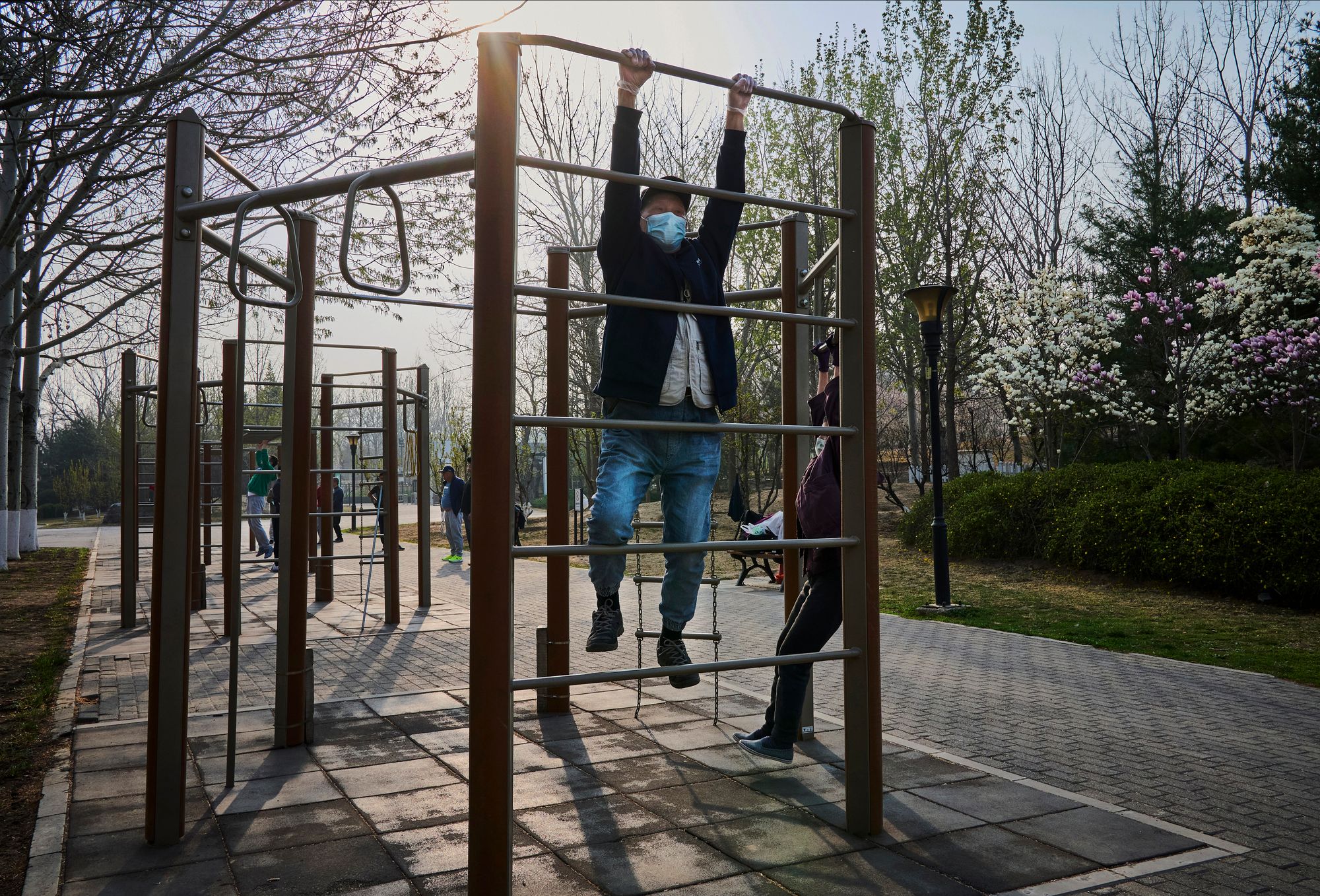 <p>File. An elderly man exercises in a public park</p>