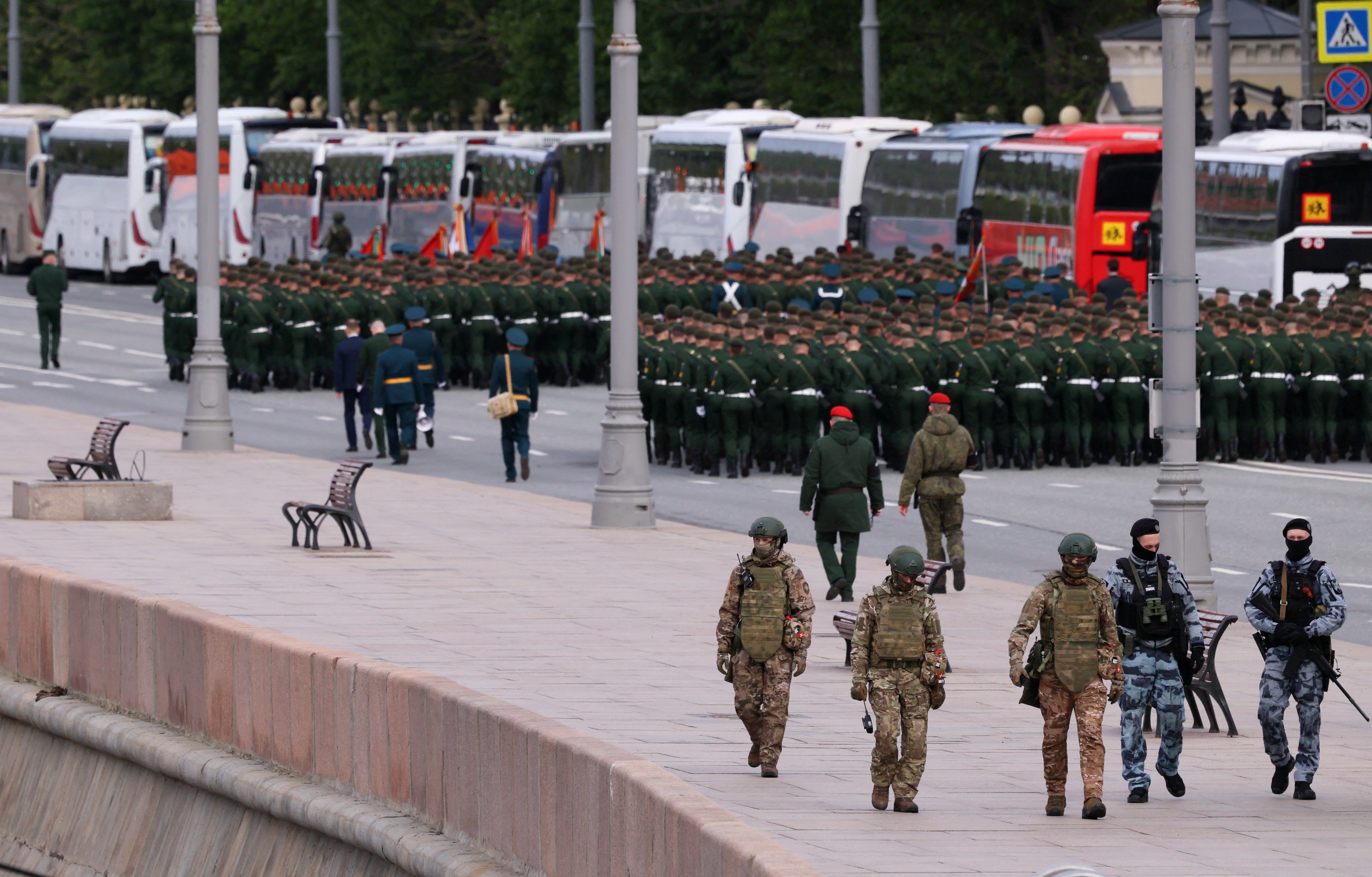 Russian security personnel patrol an area before a military parade on Victory Day