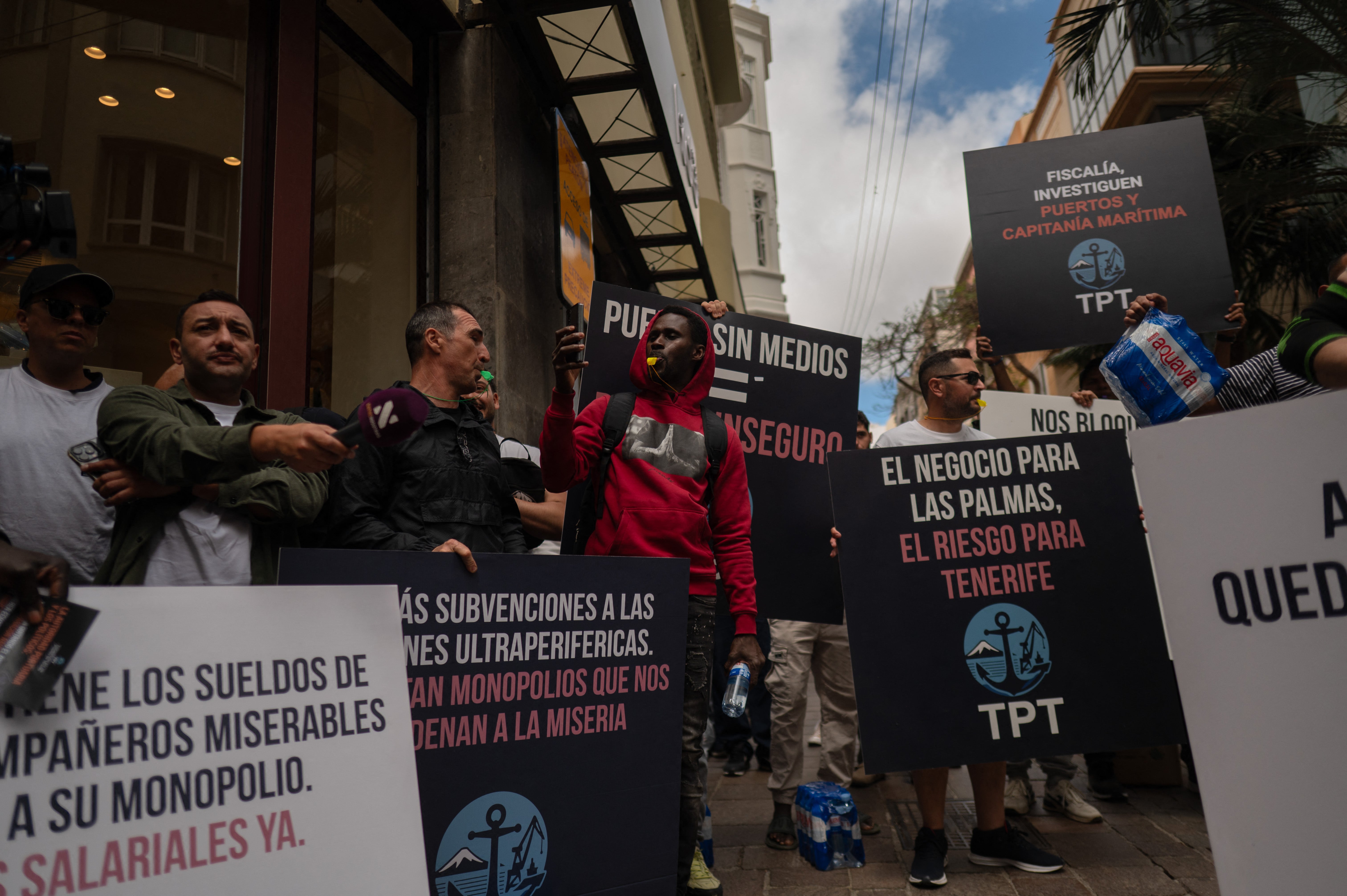Dockers hold banners reading 'Workers of Tenerife port - TPT - Port without means, Port unsafe' as they protest against the arrival of a cruise ship affected by hantavirus in Santa Cruz de Tenerife on May 8