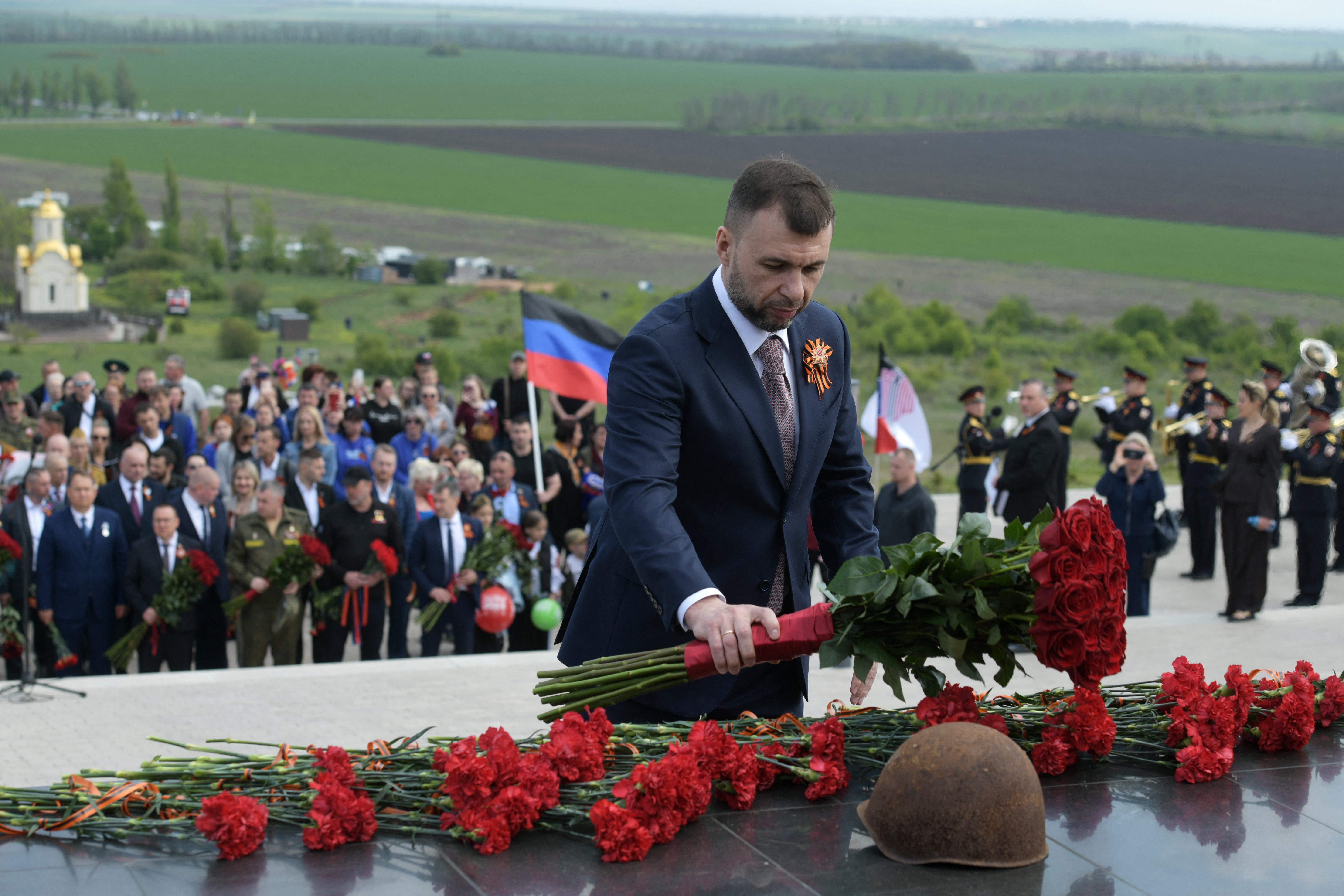 Denis Pushilin, the Moscow-installed head of the Donetsk region of Russian-controlled Ukraine, lays flowers during a ceremony marking the 81st anniversary of the victory over Nazi Germany