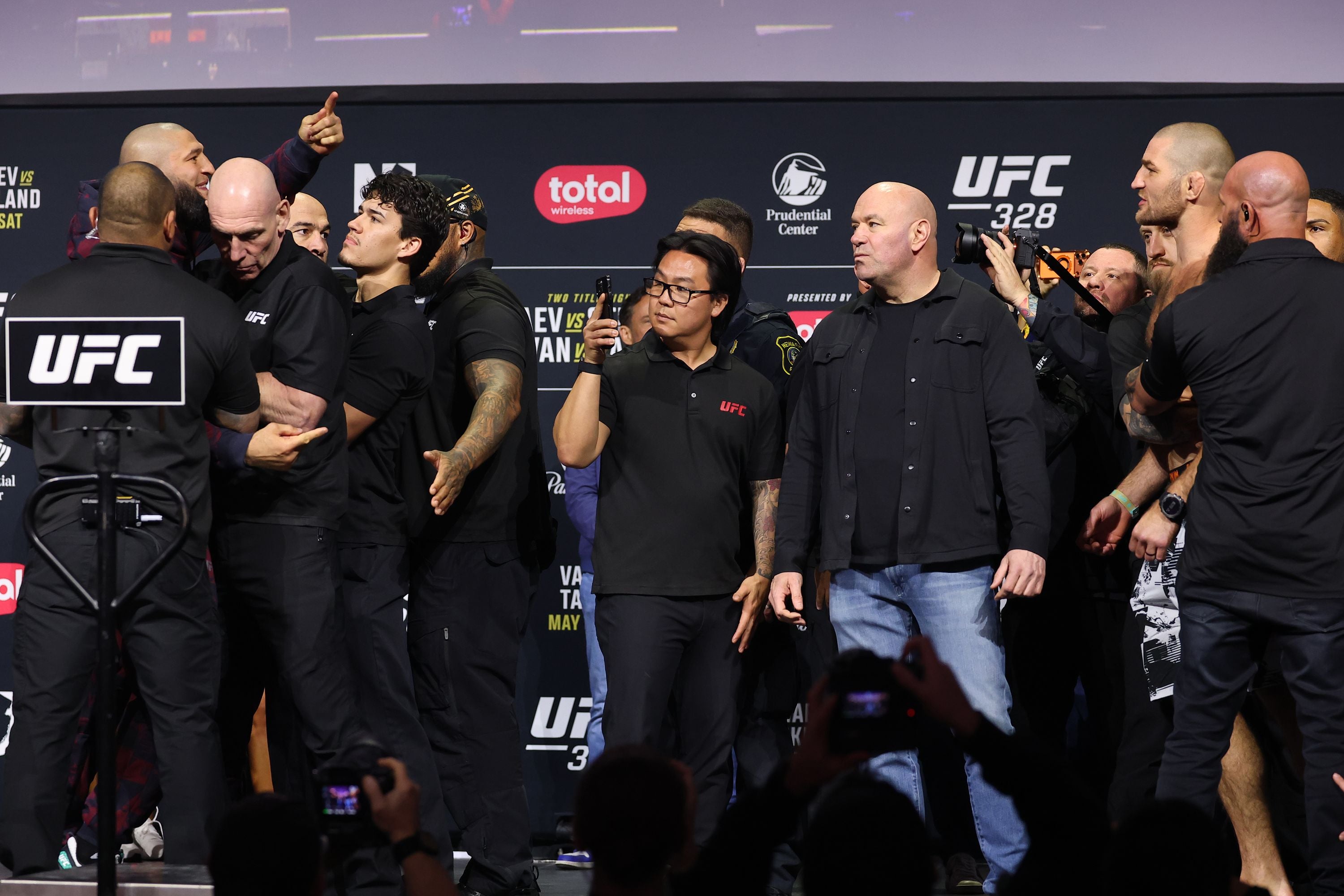 Chimaev (left) and Strickland being held back from one another at their pre-fight press conference
