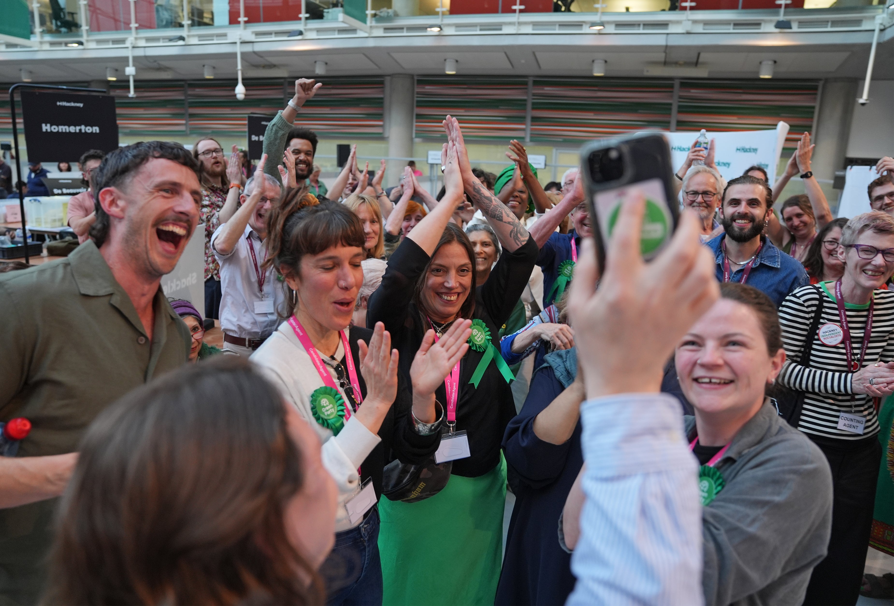 Green Party supporters congratulated candidate Florence Cullen-Davies, who was declared the winner of the 2026 London Hackney Borough Council election and was about to give birth at home and appeared live via WhatsApp video from her mobile phone