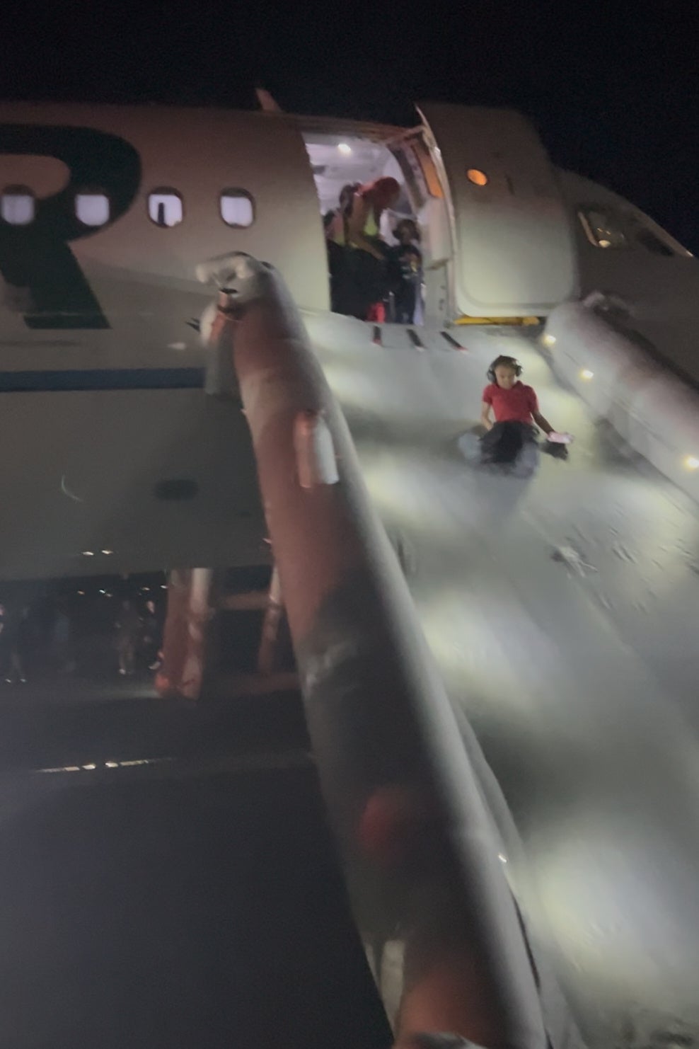 Passengers evacuated onto the runway via an inflatable slide