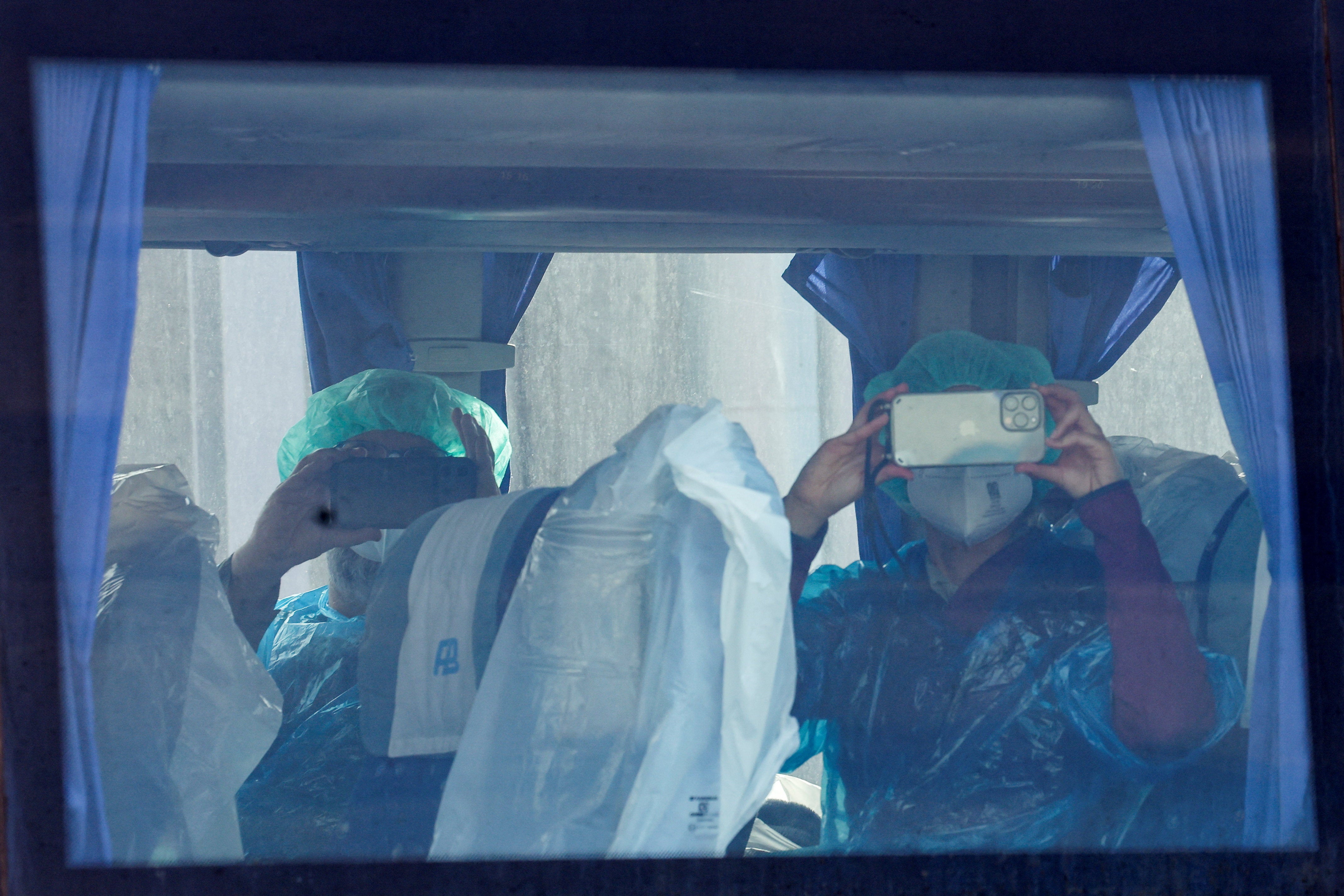 Passengers from the cruise ship MV Hondius, affected by a hantavirus outbreak, record using their mobile phones