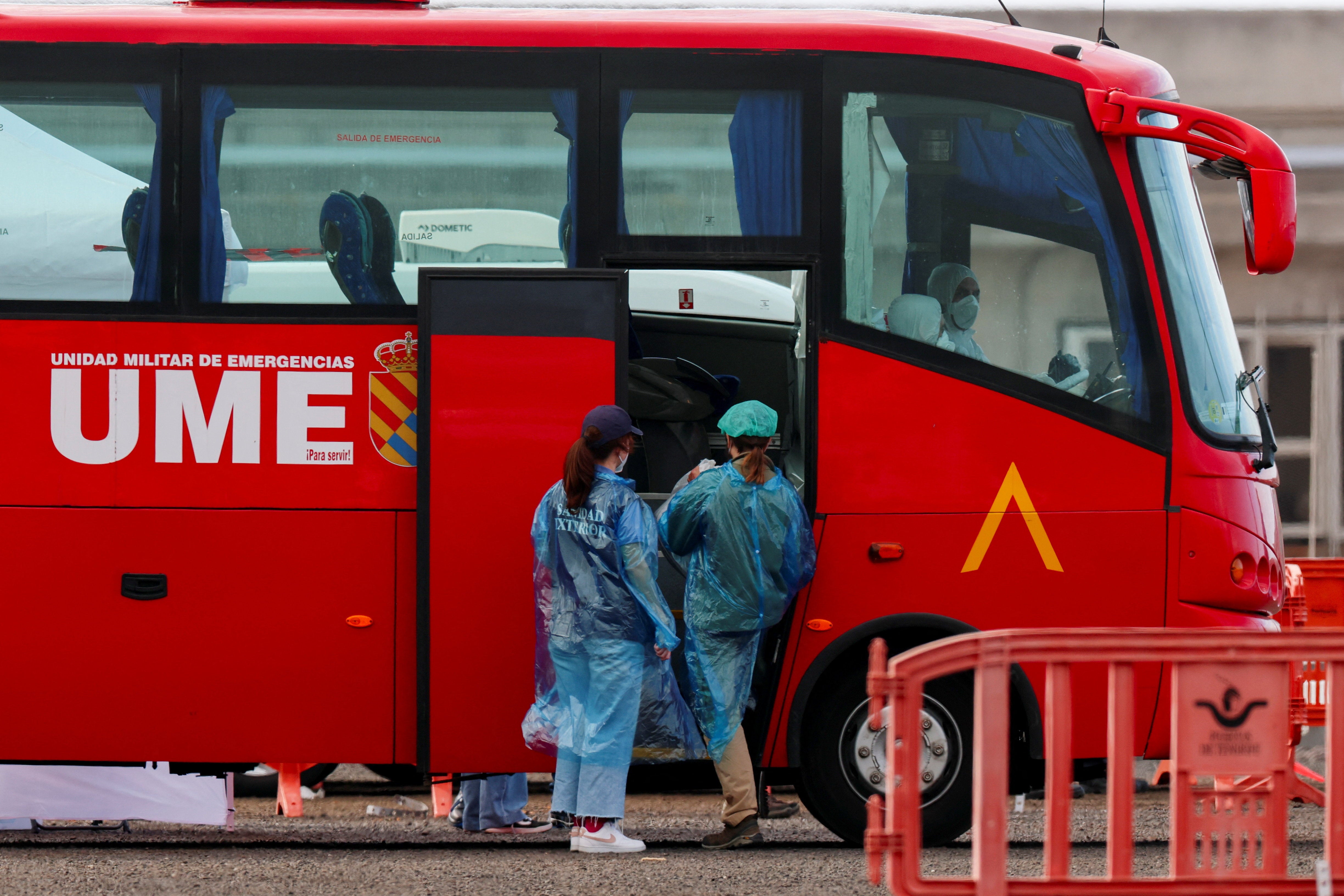 Passengers board a bus for evacuation