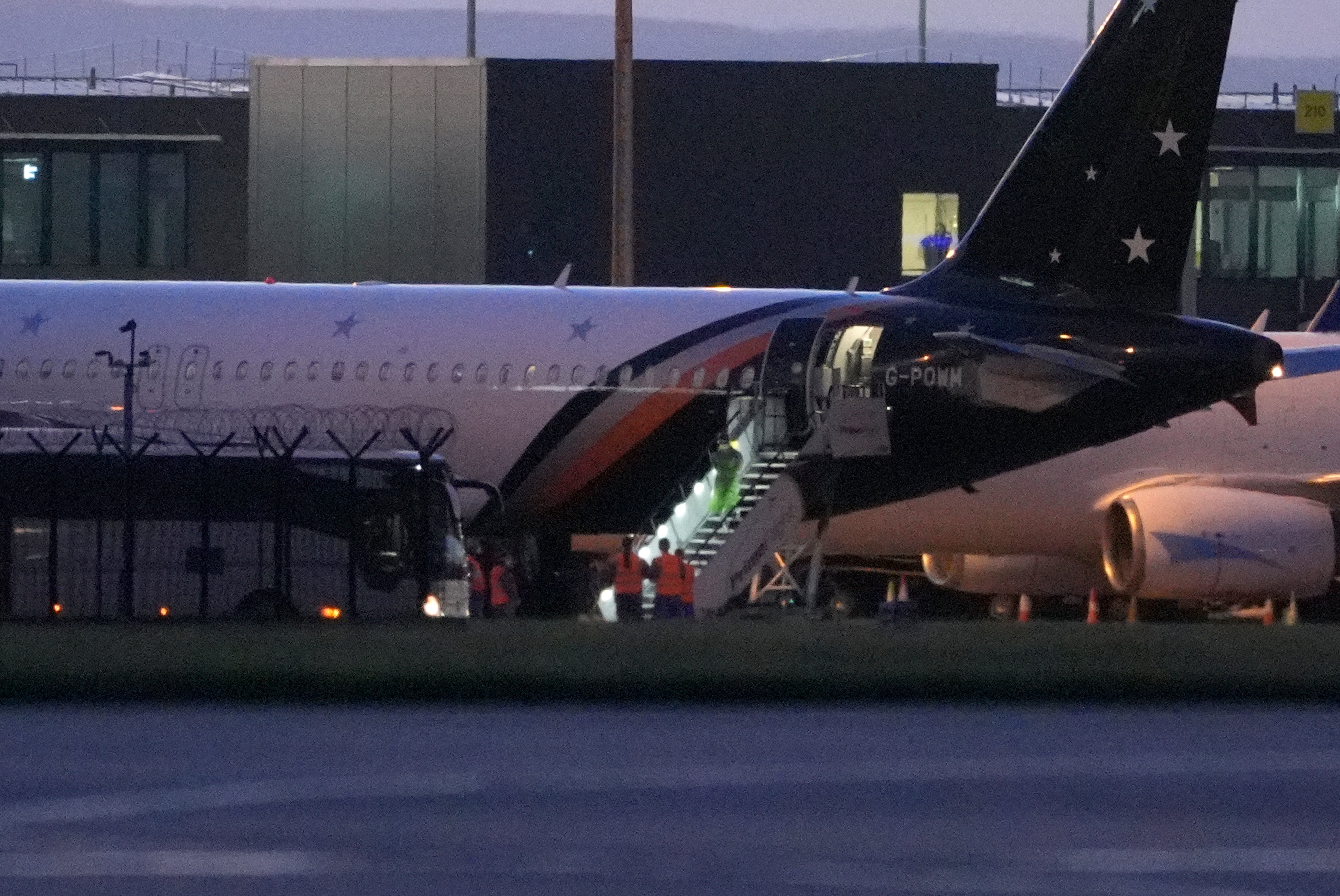 Passengers leaving a plane at Manchester Airport, after being repatriated to the UK from cruise ship MV Hondius, which was hit by hantavirus