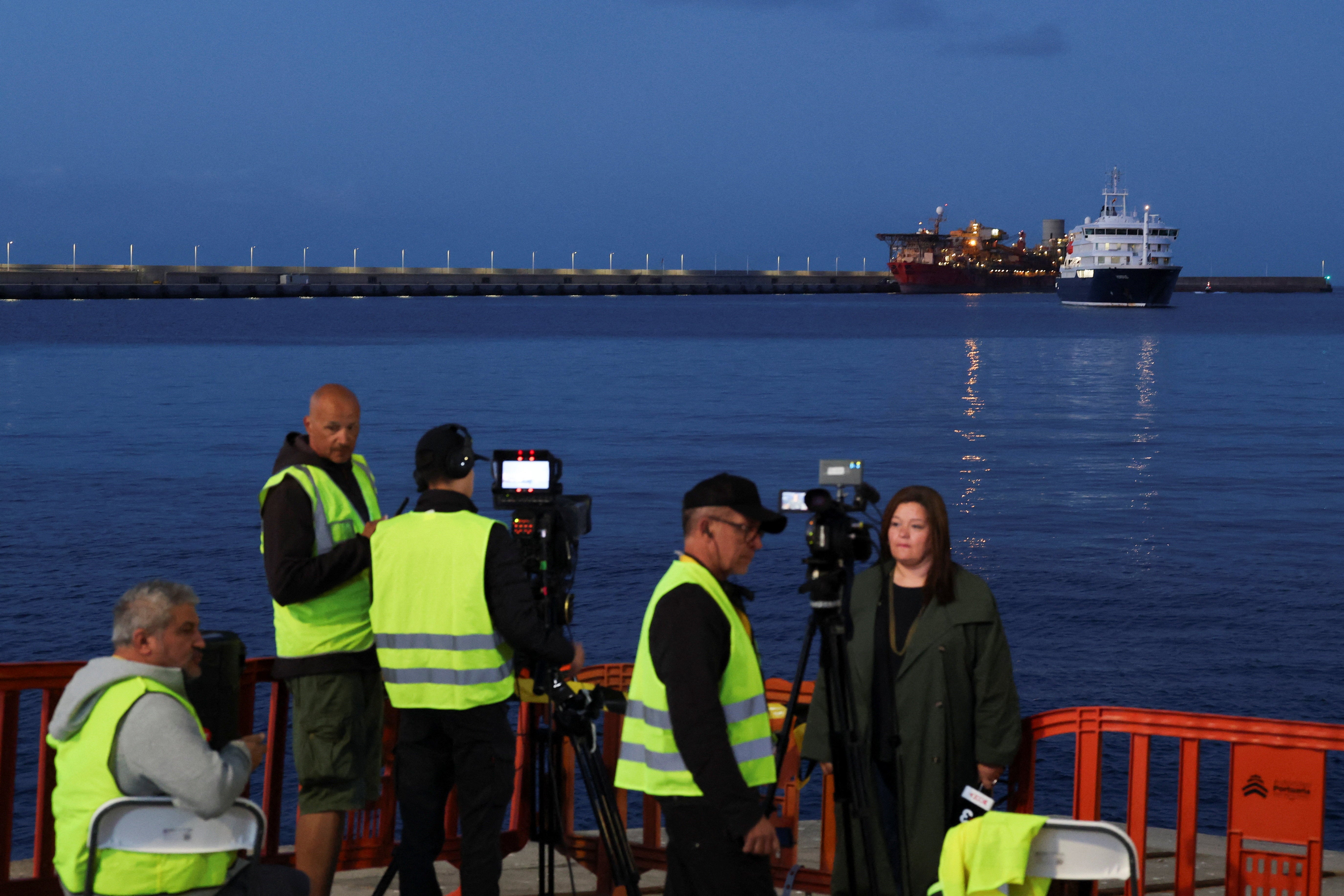 Members of the media work at the port of Granadilla de Abona following the arrival of the cruise ship MV Hondius, affected by a hantavirus outbreak, in Tenerife, Spain