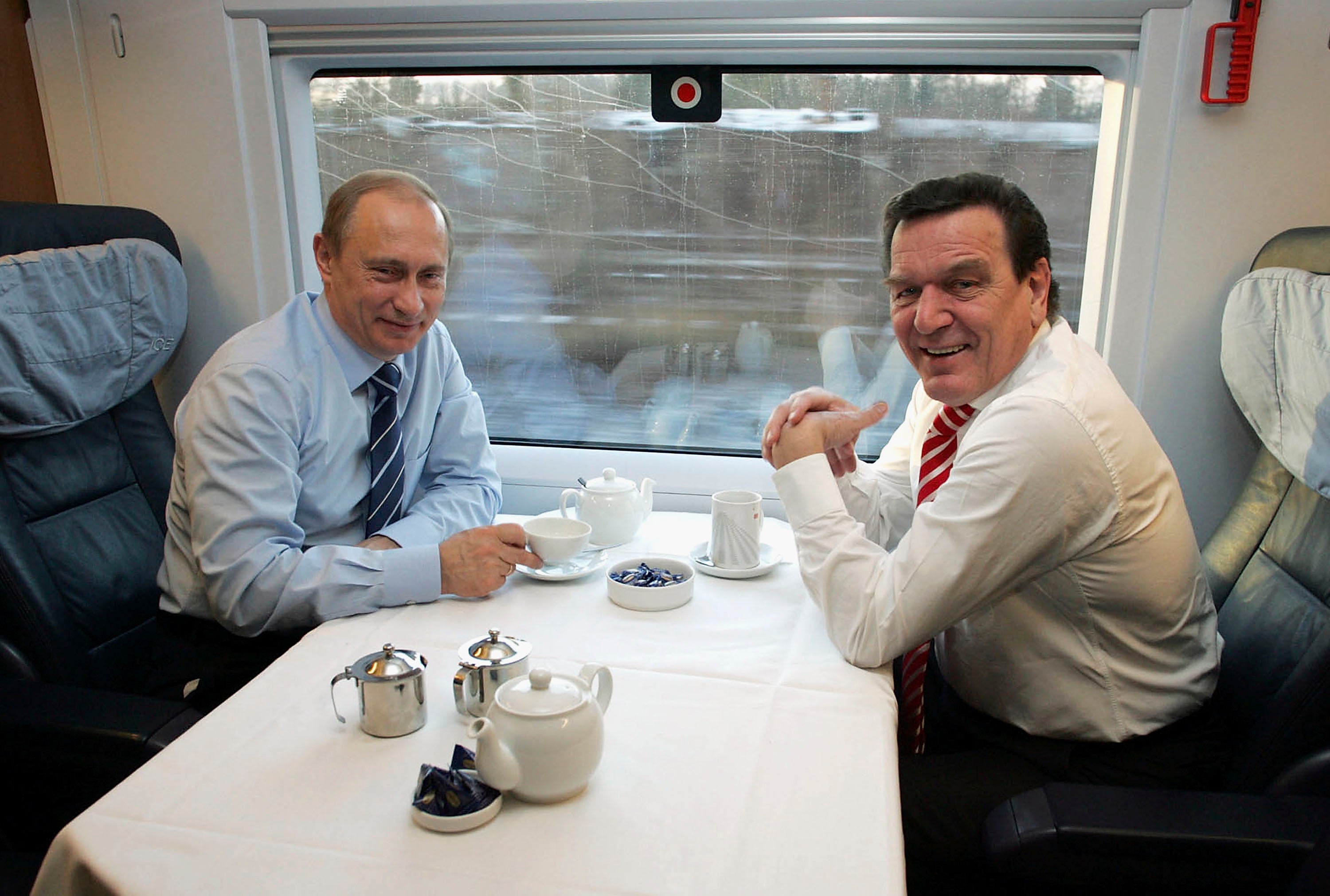 The Russian president and German chancellor Gerhard Schroeder travel on a high-speed train in 2004
