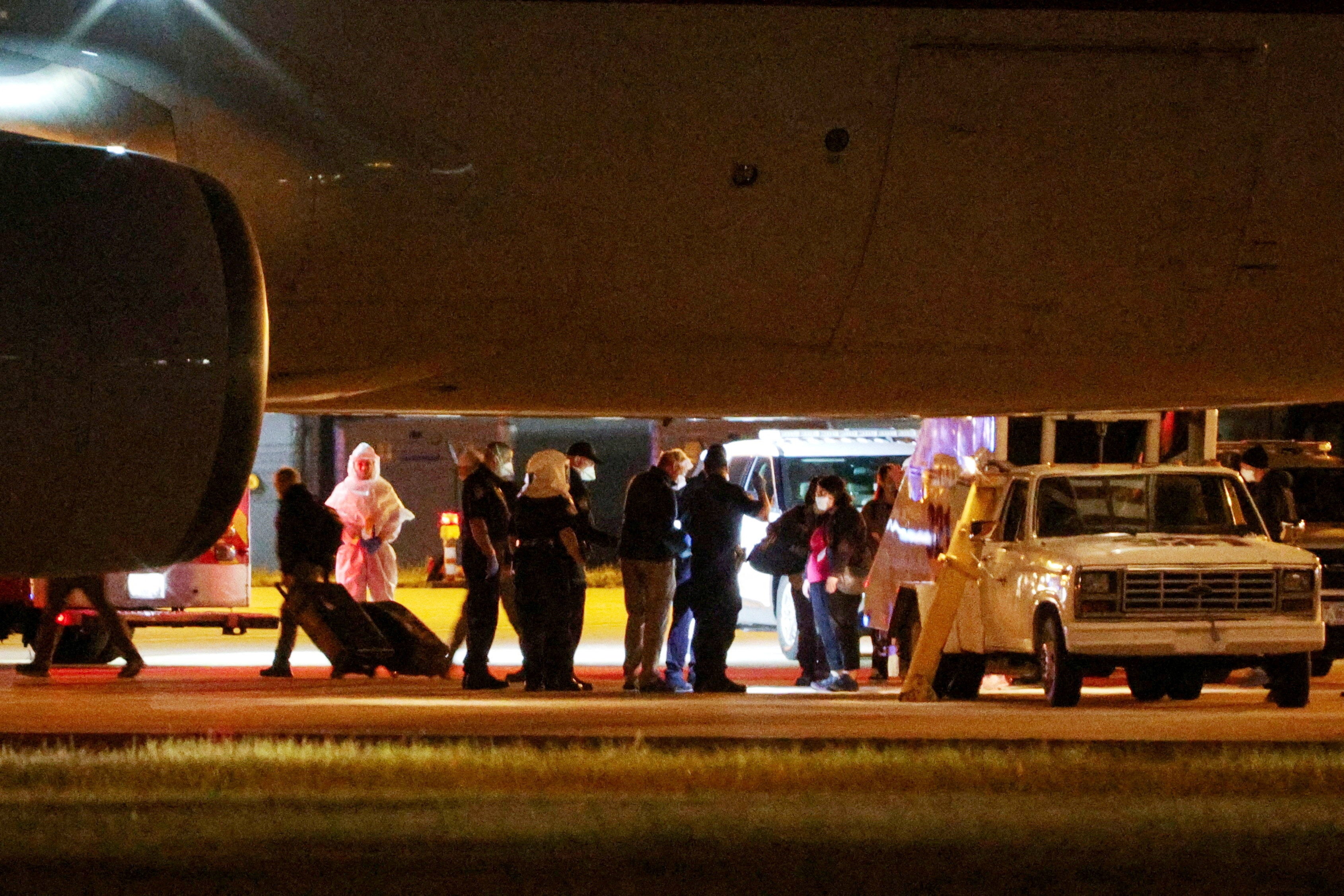 Personnel from various agencies assist in the disembarkation of passengers evacuated from the cruise ship MV Hondius, as they arrived on a chartered aircraft at Eppley Airfield in Omaha, Nebraska