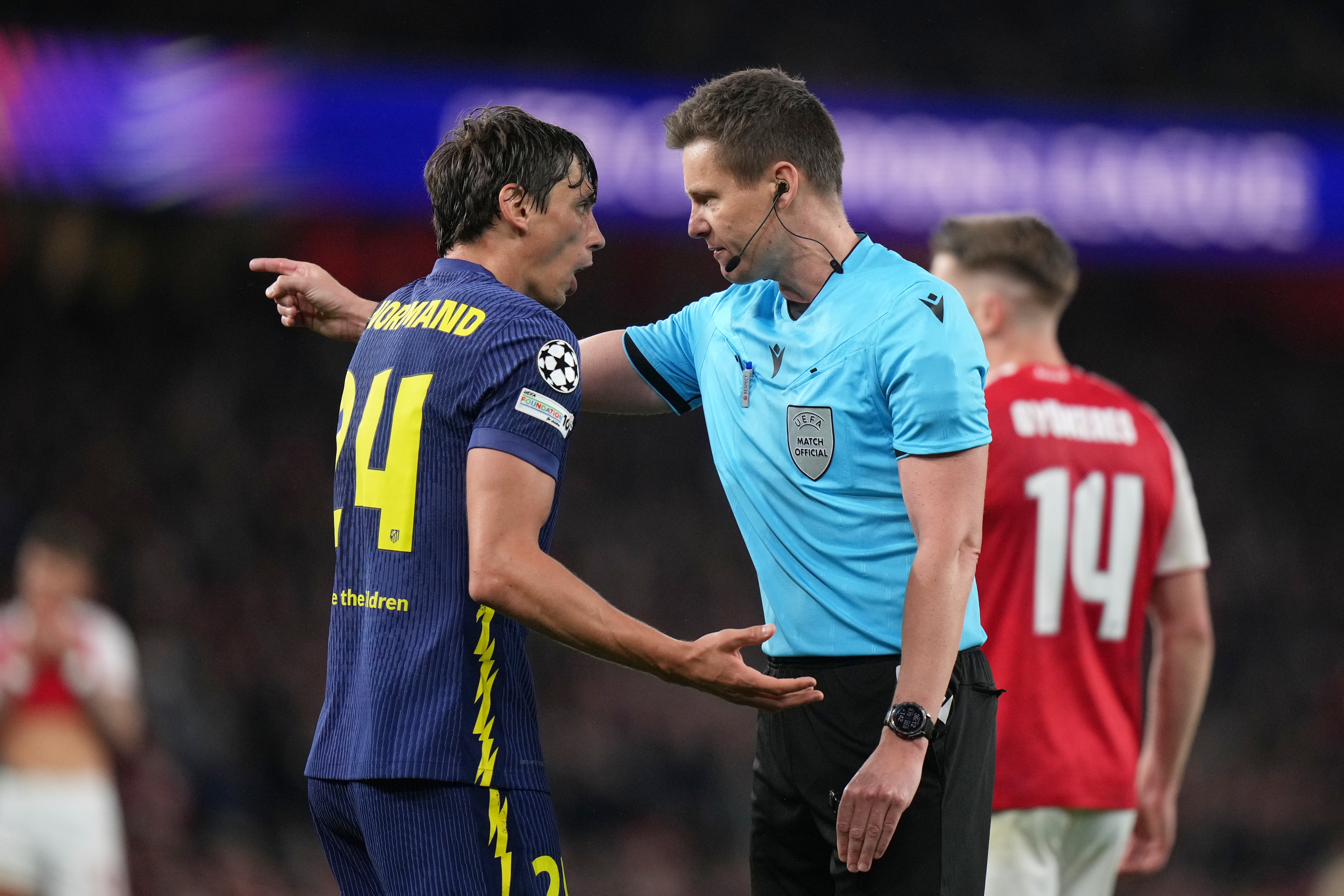 Atletico Madrid's Robin Le Normand speaks to Referee Daniel Siebert