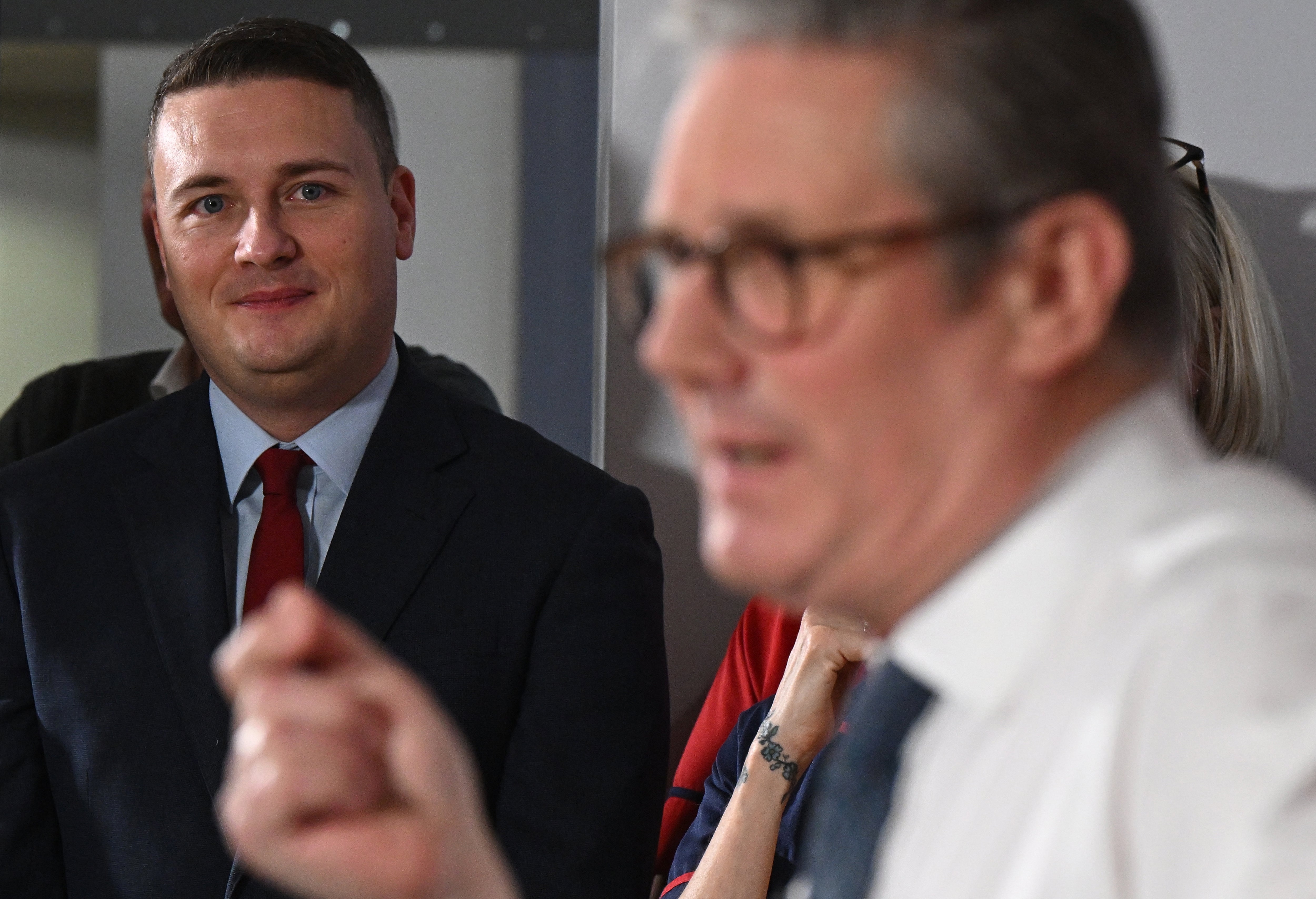 Wes Streeting (L) listens as Keir Starmer delivers a speech in 2025