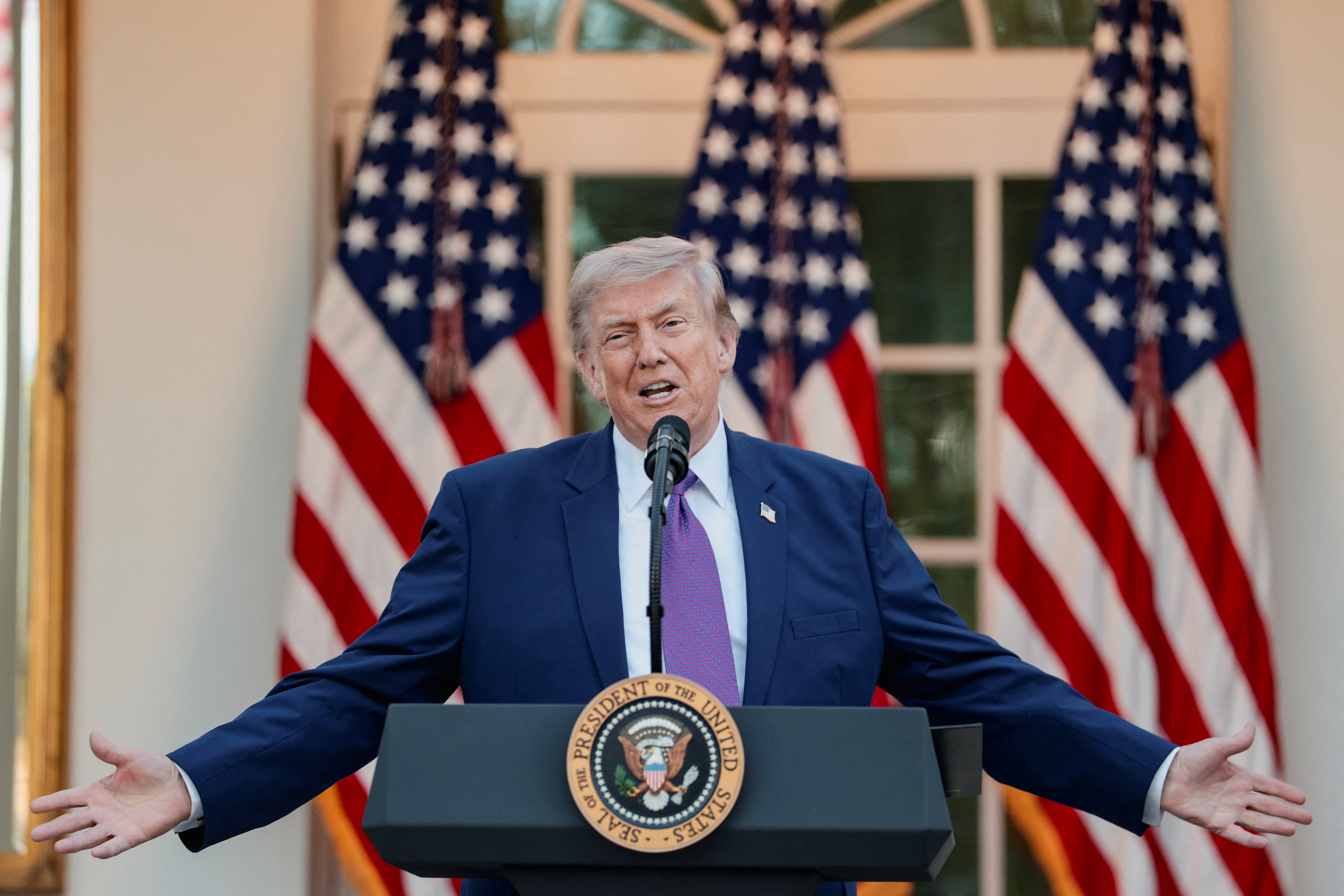 U.S. President Donald Trump gestures while delivering remarks as he hosts his second 'Rose Garden Club' dinner in honour of Police Week at the White House