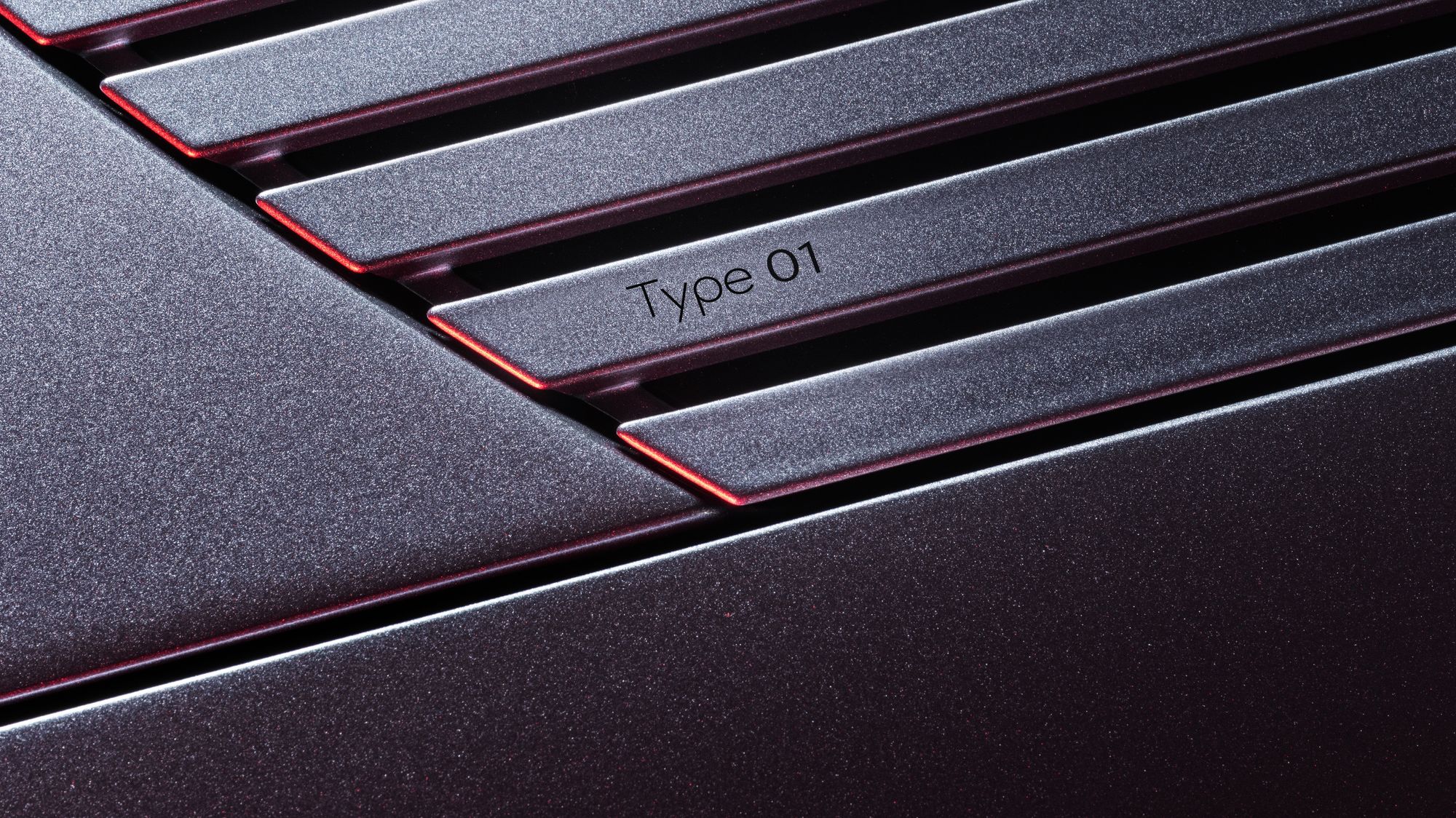 The Jaguar Type 01 name appears on the strikethrough graphic where the car's long bonnet meets the windscreen.