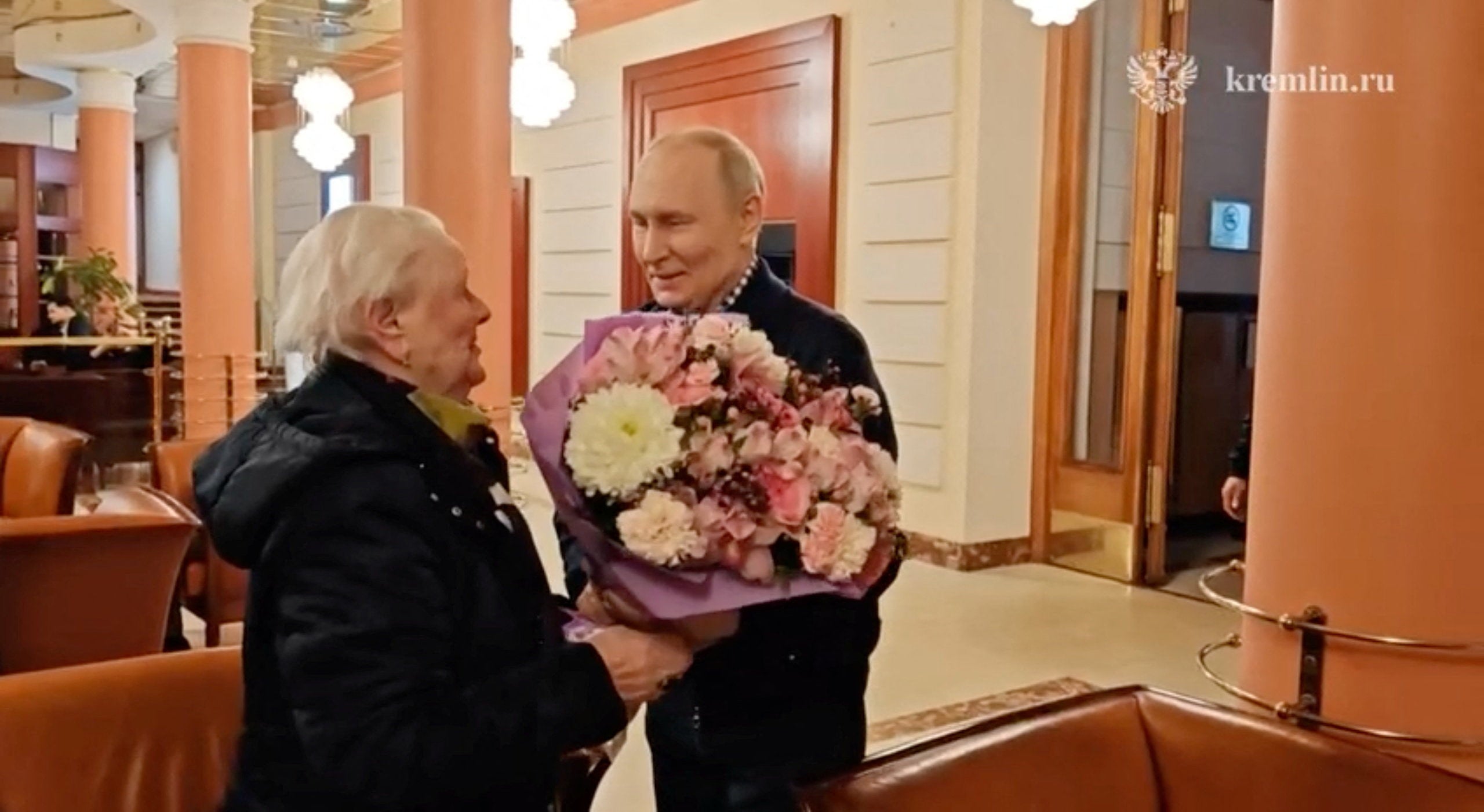 Russian President Vladimir Putin meets his former school teacher Vera Gurevich at a hotel in Moscow, Russia, in this still image from video released on May 11