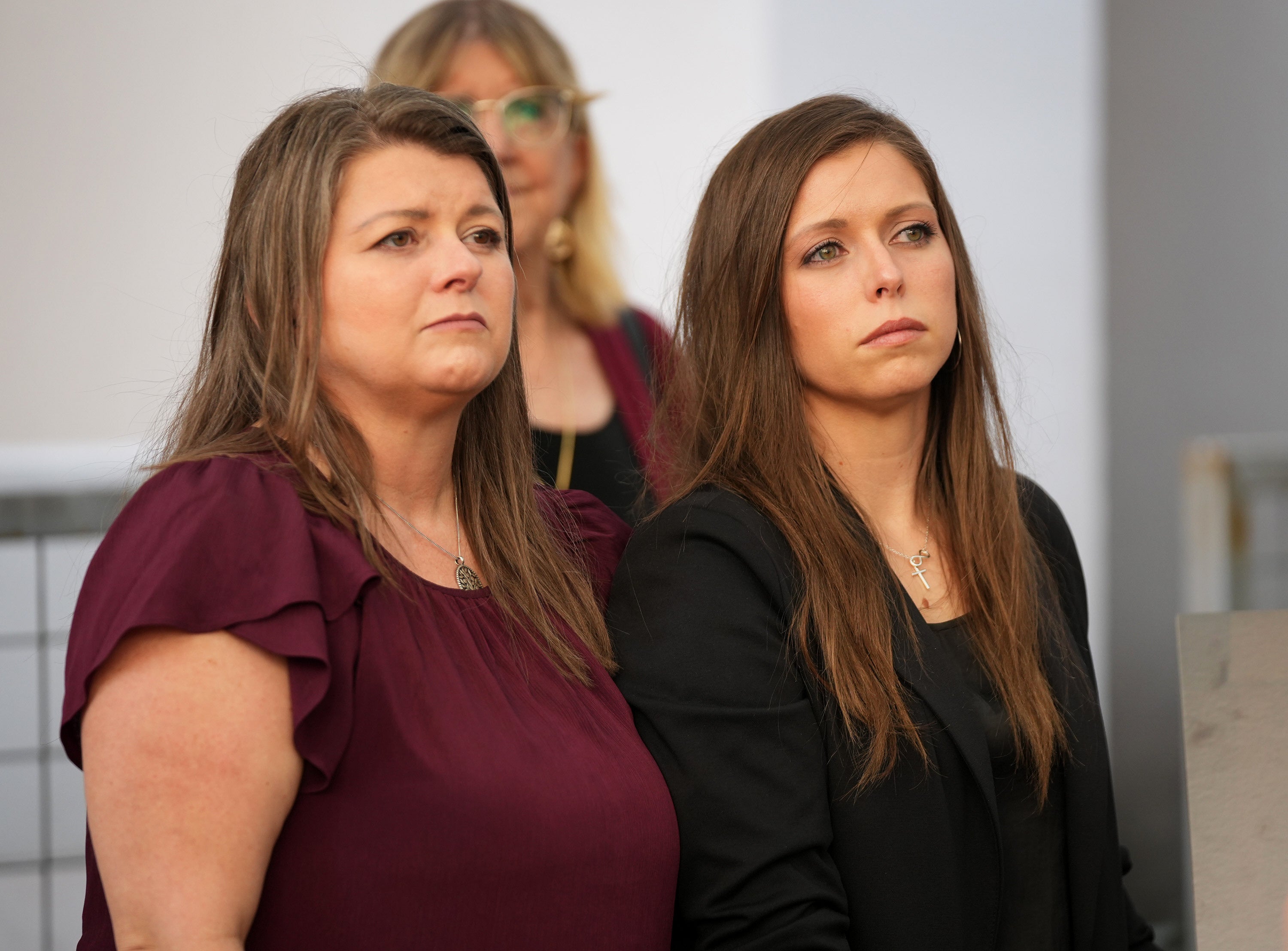 Kim Pierce, left, the widow of yogurt shop suspect, Maurice Pierce, and their daughter, Marisa