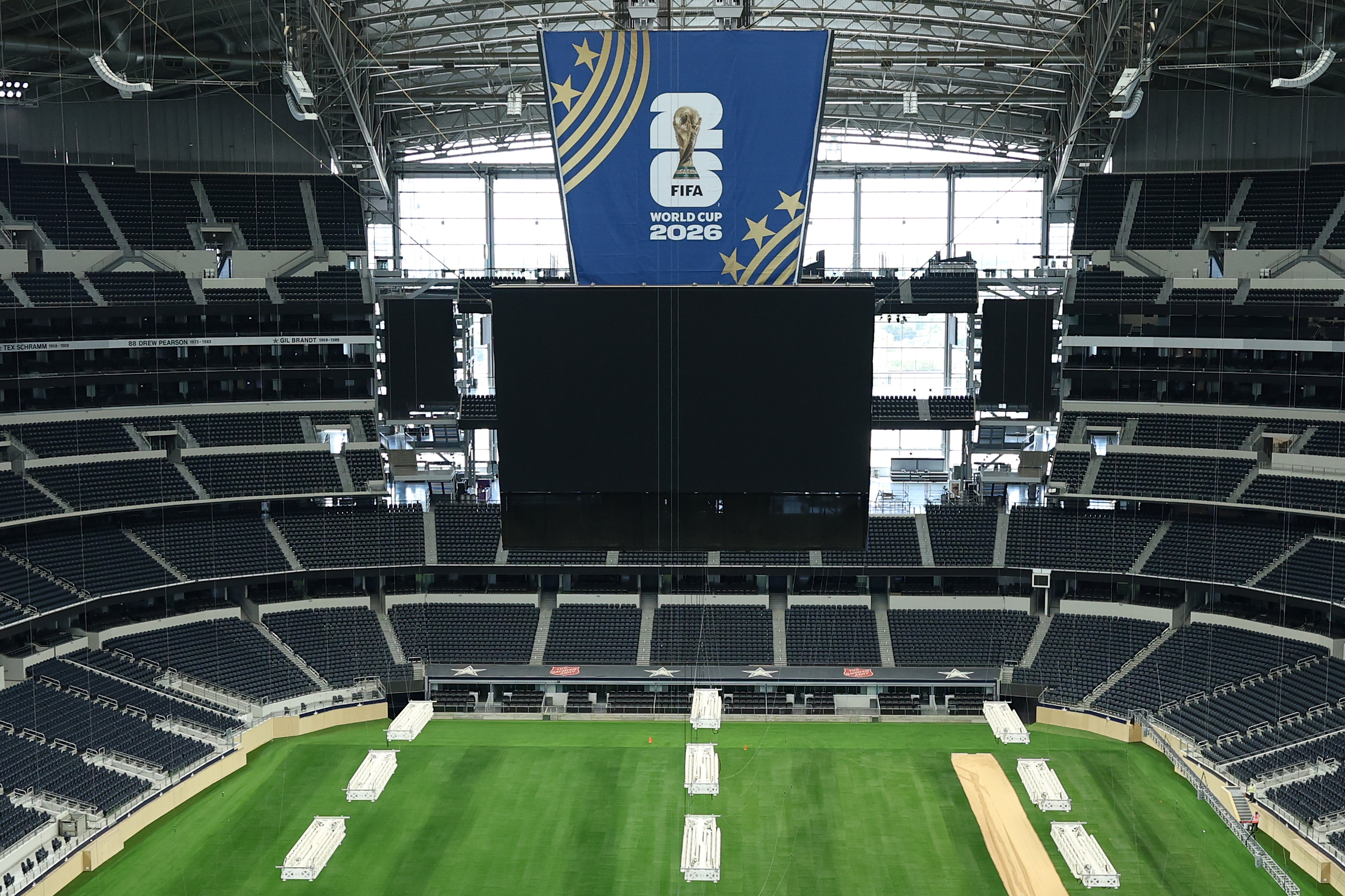 The tournament will take place across 11 US host cities, as well as those in Canada and Mexico. Pictured here is AT&T Stadium in Dallas with its Jumbotron draped in FIFA World Cup branding