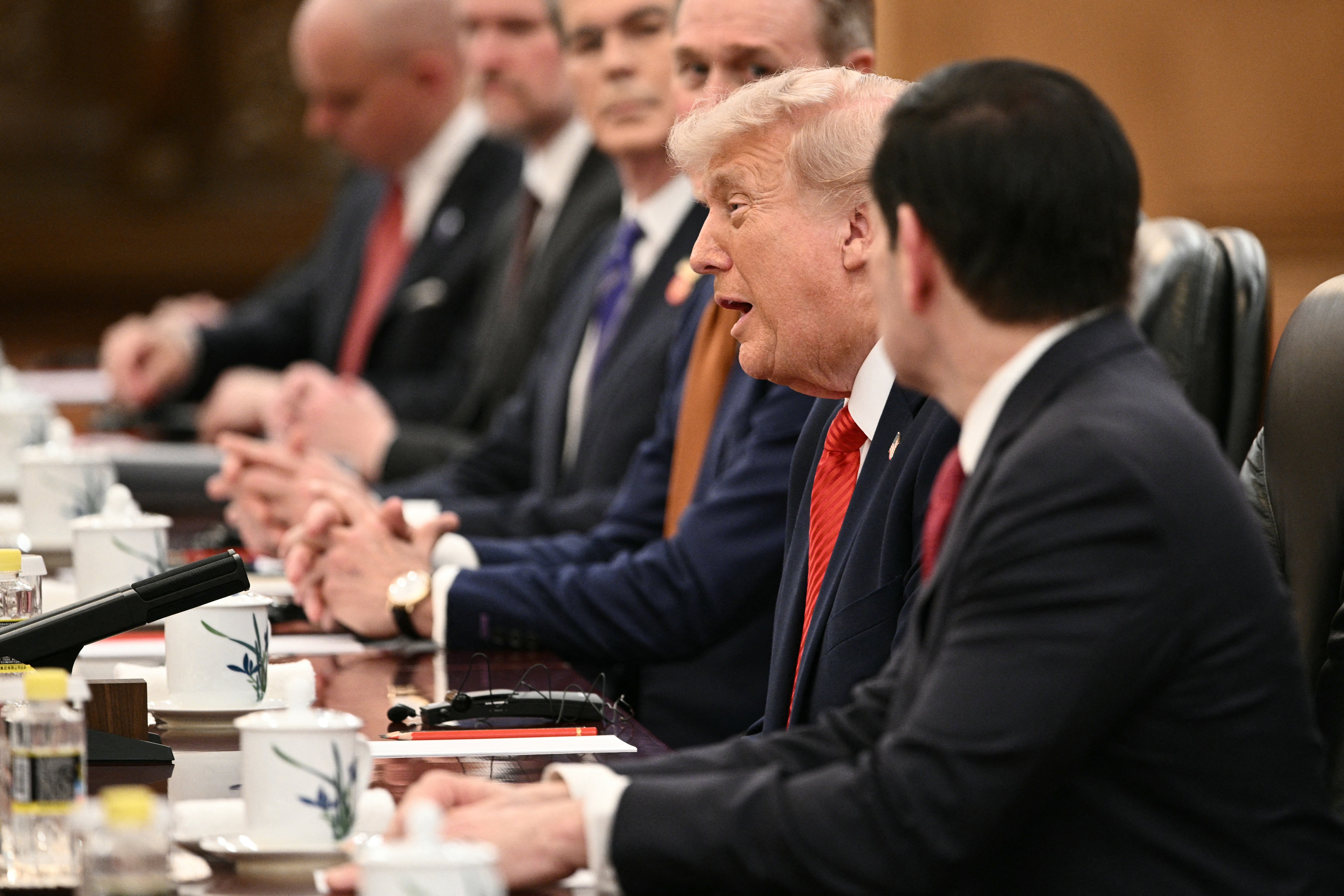 US President Donald Trump (C) speaks next to Secretary of State Marco Rubio (R) during a meeting with China's President Xi Jinping at the Great Hall of the People in Beijing
