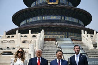 China's President Xi Jinping (2nd R) and US President Donald Trump (2nd L) pose for a photo with Eric Trump (R) and his spouse Lara Trump at the Temple of Heaven in Beijing