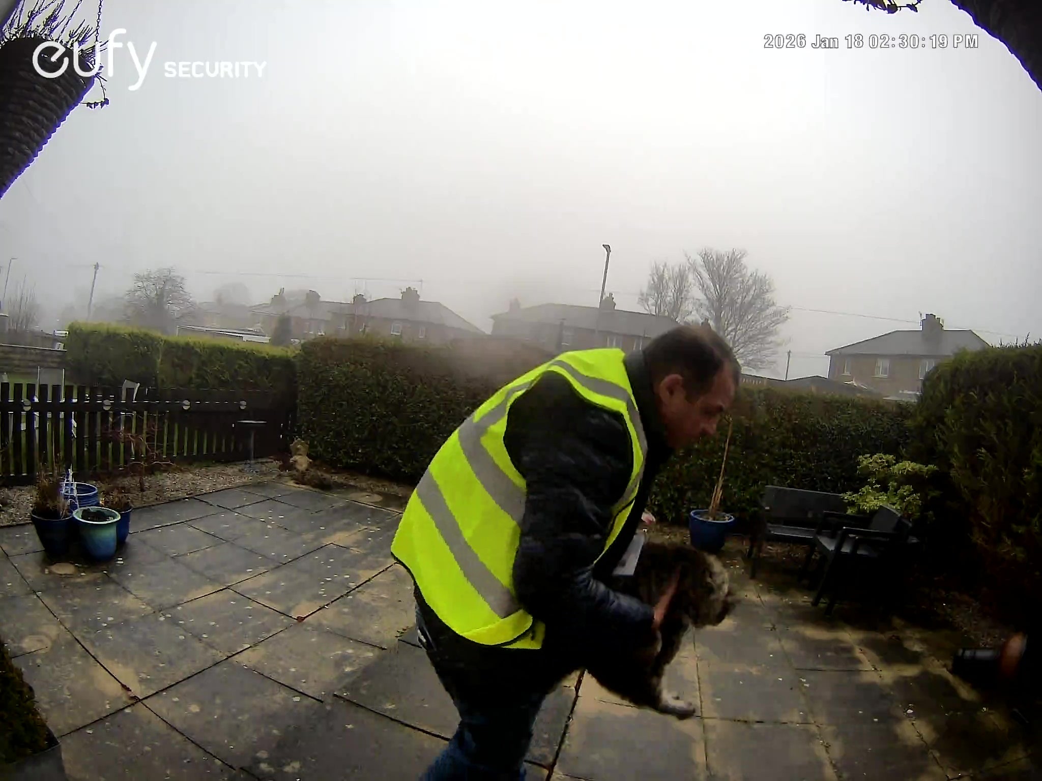 Screenshot taken from doorbell camera footage of Amazon delivery driver Catalin Stancu taking Nora the cat away.