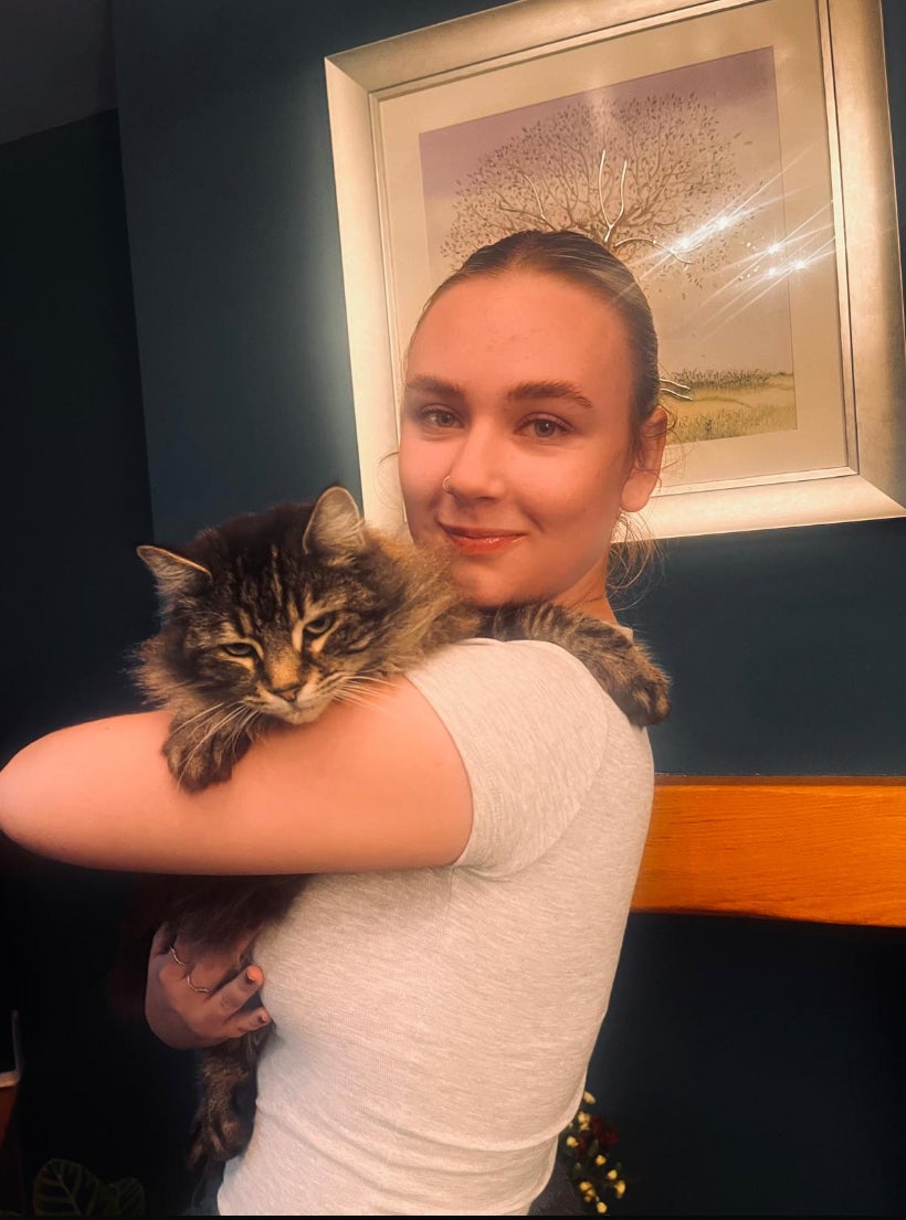 Kyla Sharpe with her cat Nora.