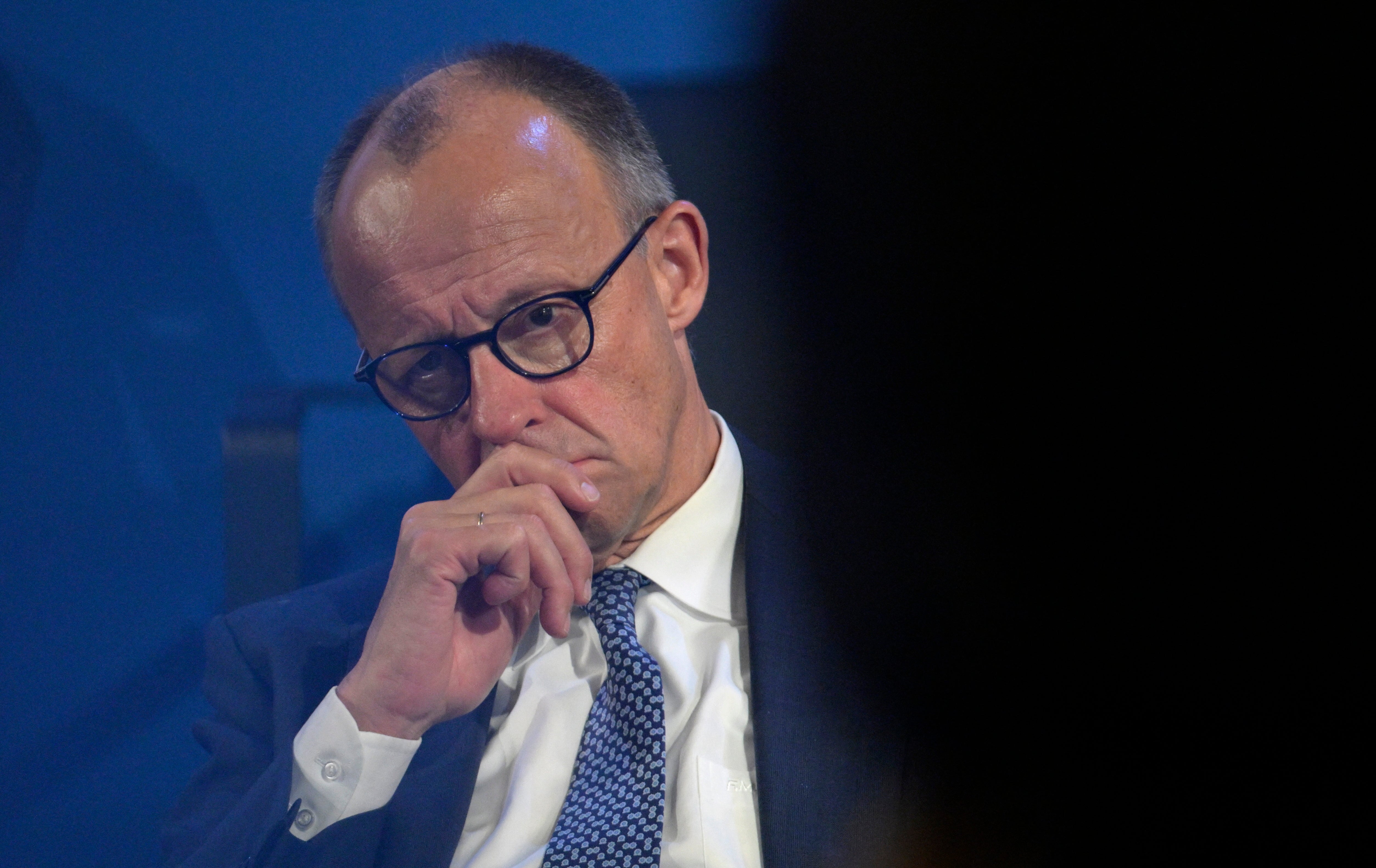 German chancellor Friedrich Merz listens to speeches in Aachen, western Germany