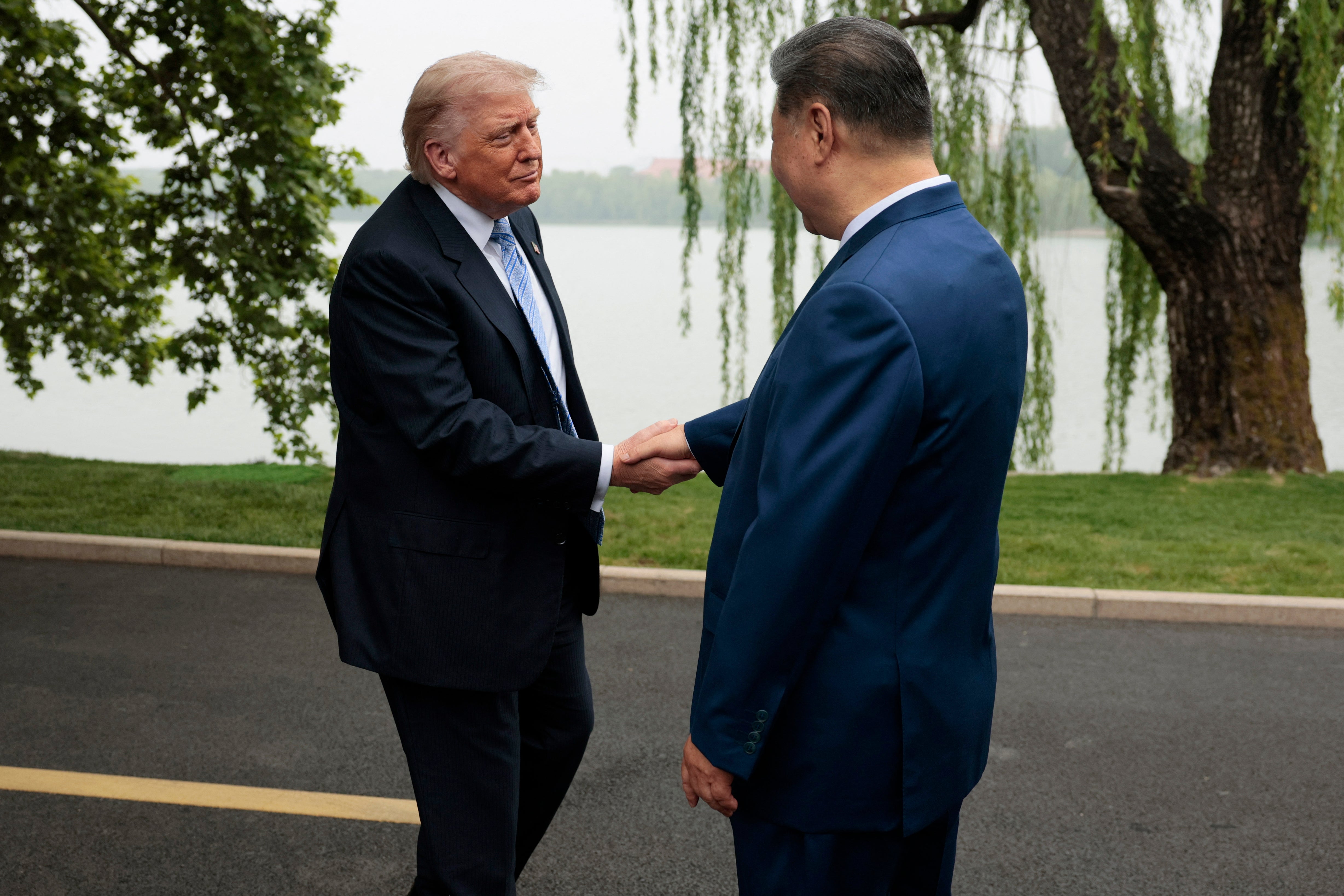 US President Donald Trump (L) is greeted by Chinese President Xi Jinping at Zhongnanhai Garden (AFP/Getty)