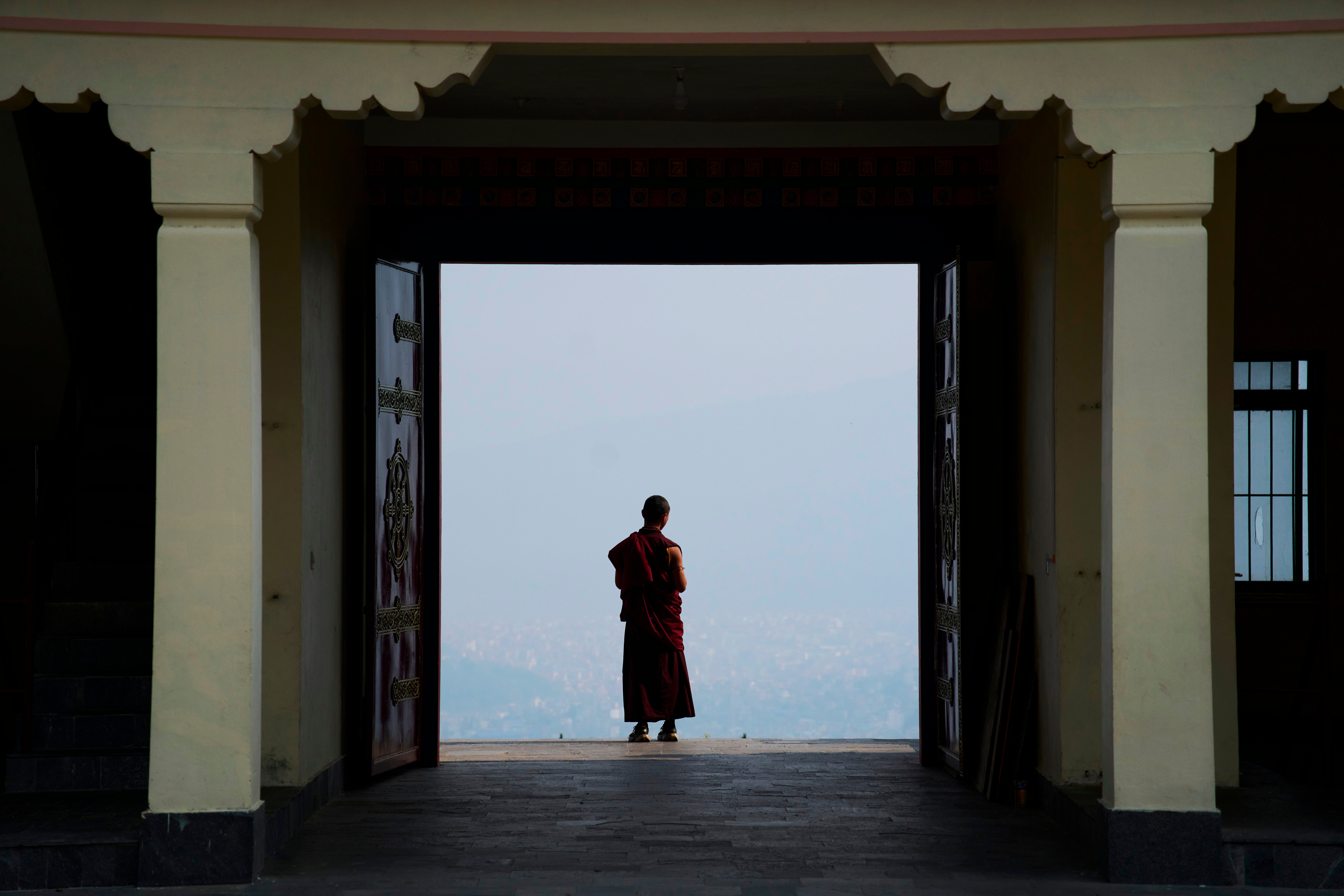 A Buddhist monk takes a break from a ritual at Dzarong Thubten Mindrol Dongä Monastery in Kathmandu, Nepal