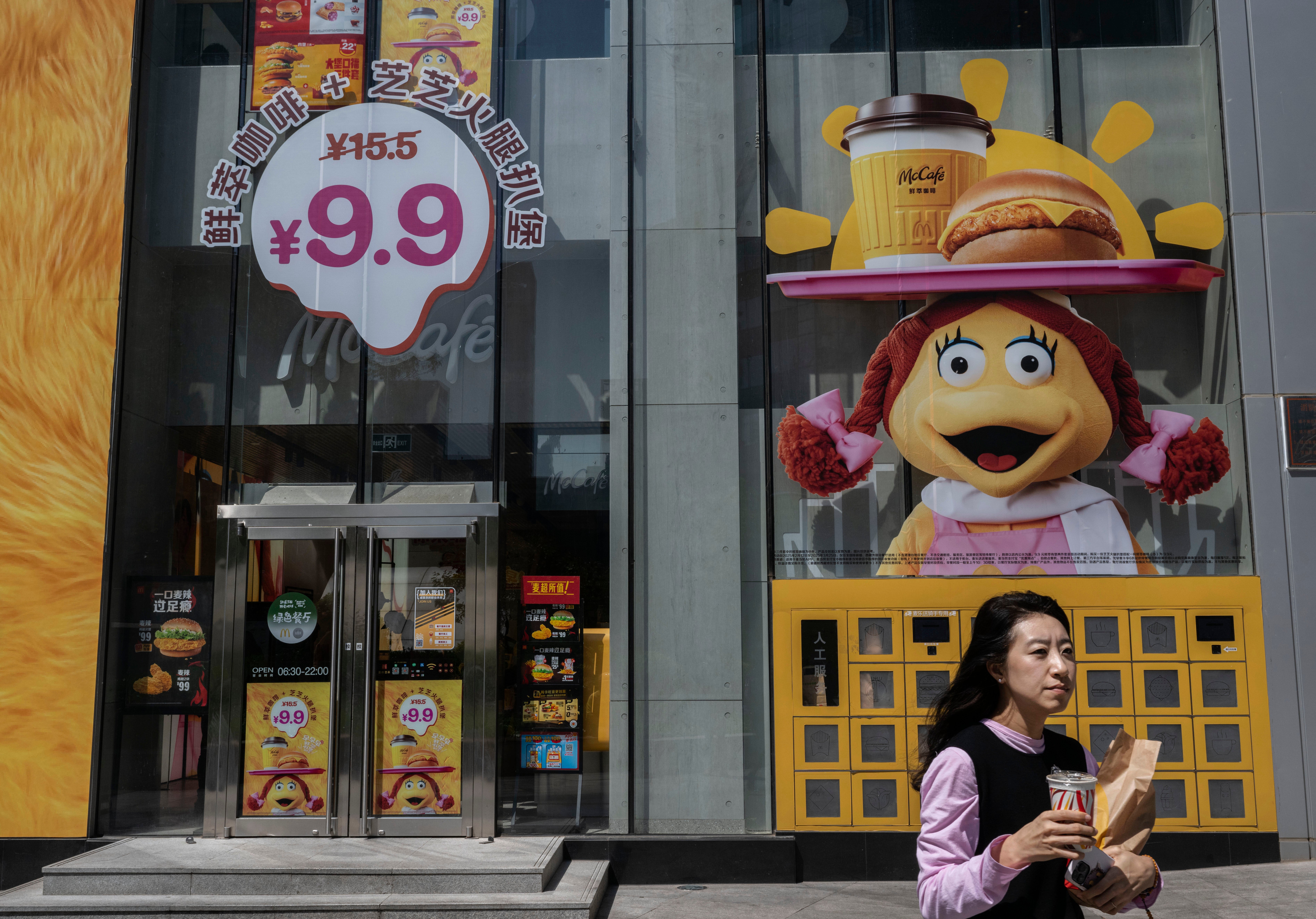 A woman carries her order from a location for fast food chain McDonalds on April 25, 2025 in Beijing, China
