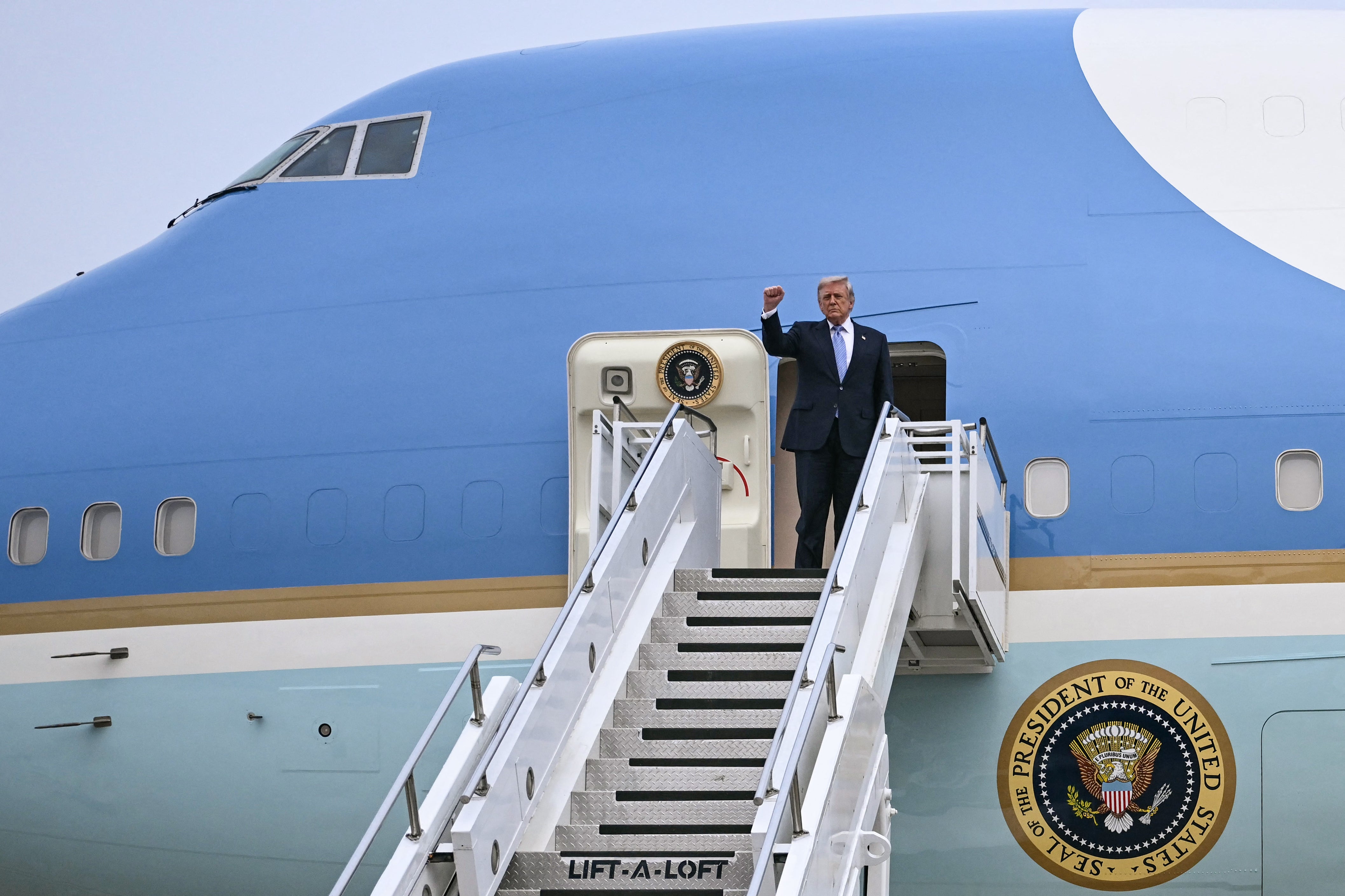 US President Donald Trump boards Air Force One before his departure from Beijing Capital Airport in Beijing on (AFP/Getty)