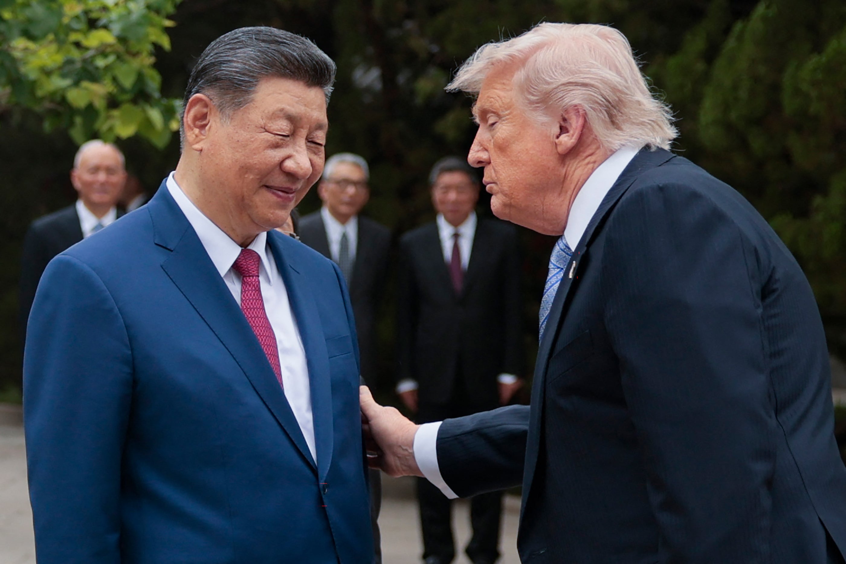 Donald Trump (R) gestures to China's President Xi Jinping as he leaves after a visit to Zhongnanhai Garden in Beijing on May 15