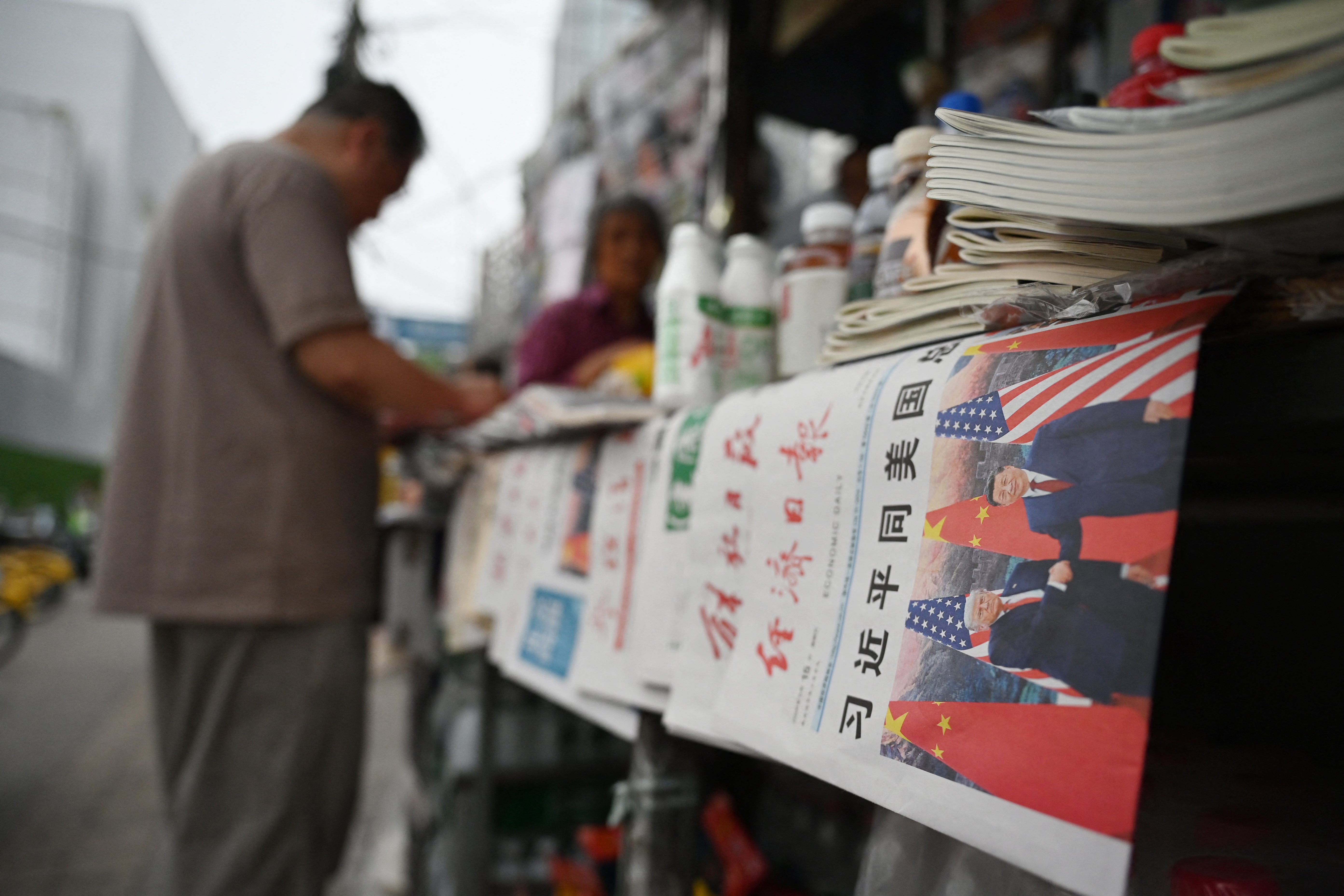 A copy of the Economic Daily newspaper with a front page photo and headline which reads "Xi Jinping holds talks with US President Trump", are displayed at a news stand in Beijing on May 15, 2026. Trump said he had made "fantastic trade deals" with China's Xi Jinping (AFP/Getty)