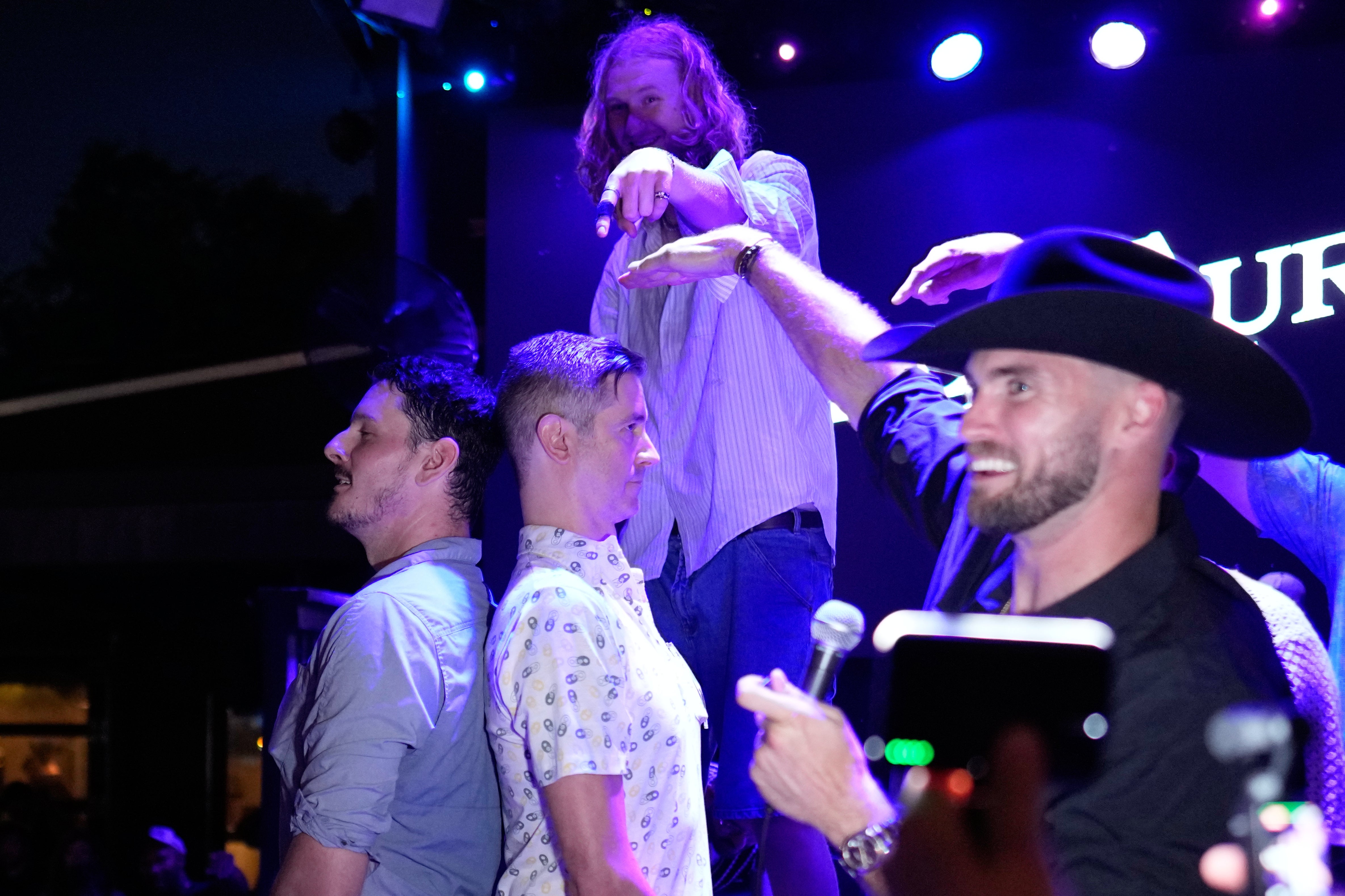 Carter Blab, left, and Weston Borghesi, stand back-to-back to see who is the tallest man attending a Tall Tour event