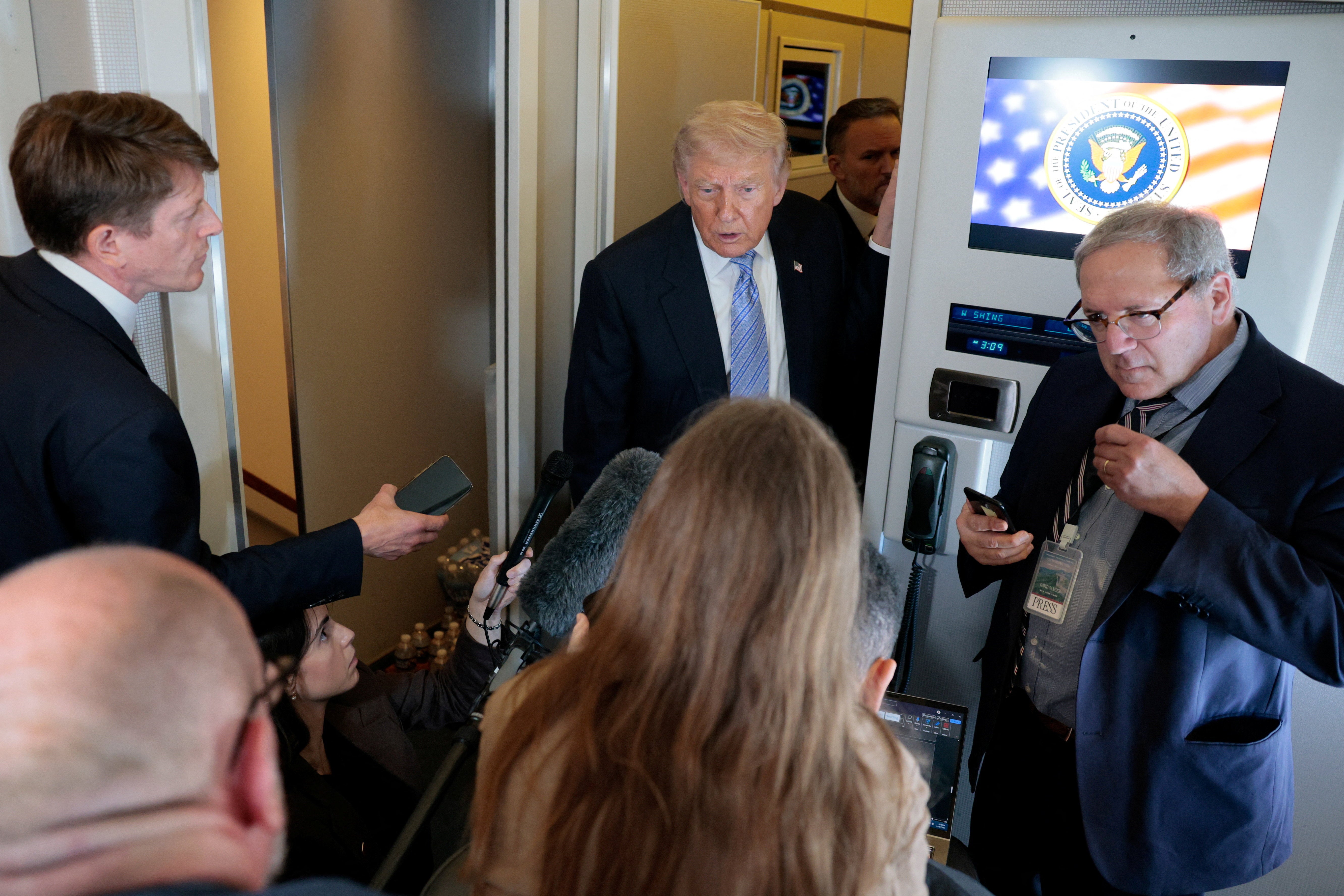 Chinese officials asked US reporters to return red lapel badges that were distributed to indicate they were part of the press pool before leaving China for the United States