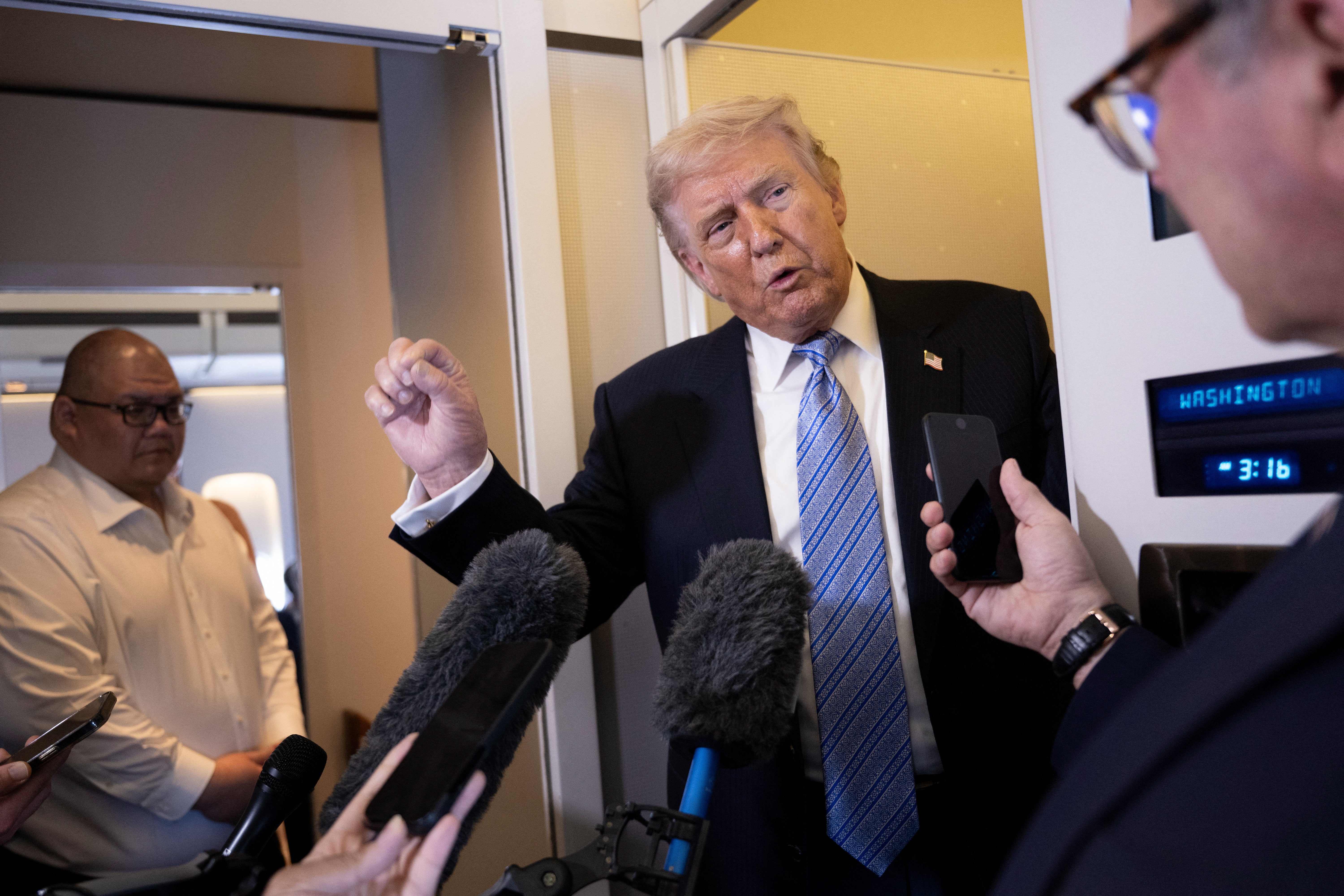 Donald Trump speaks to reporters aboard Air Force One after his departure from Beijing on May 15, heading back to the US