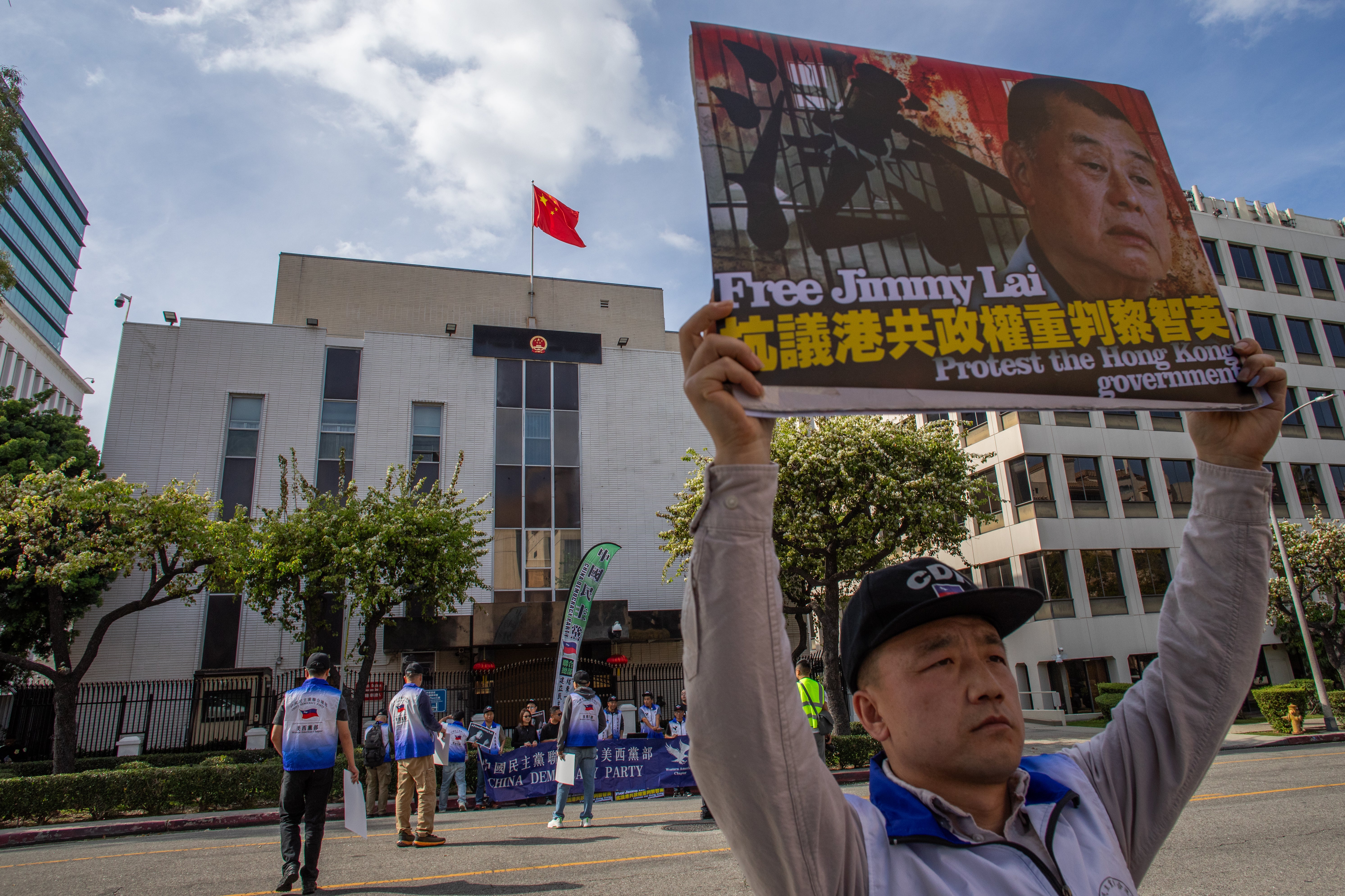 People gather in front of the Chinese Consulate General in LA to protest the unjust conviction of media entrepreneur Jimmy Lai