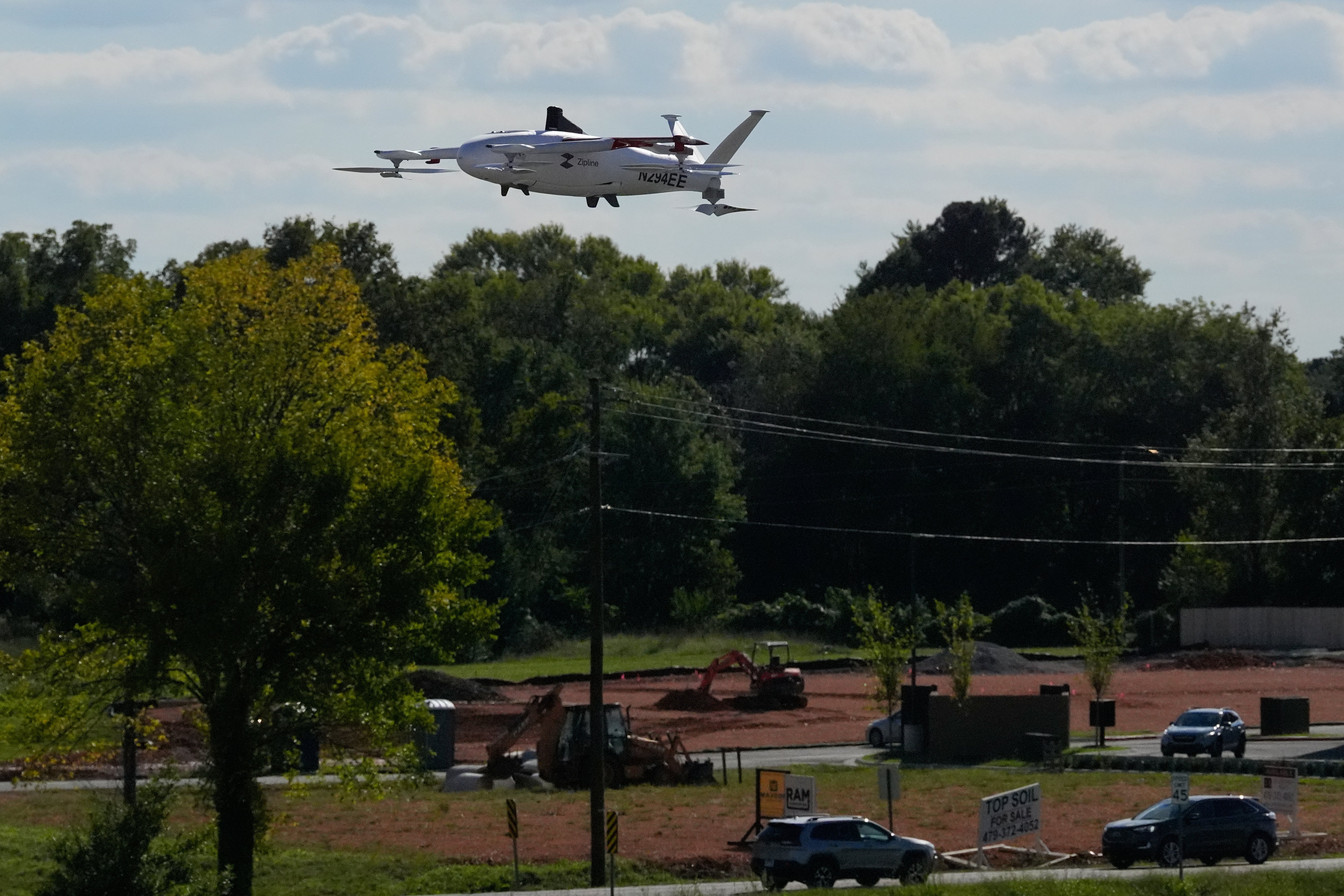 A drone operated by Zipline flies to make a delivery from a Walmart store