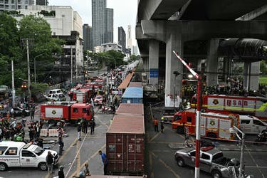 <p>Firefighters and rescuers at the site of a train collision</p>