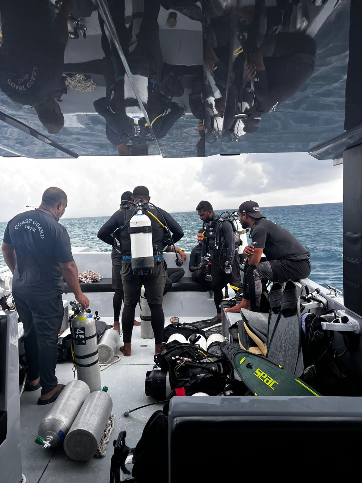 Divers preparing to search for the four missing Italian divers near Alimathaa Island, Maldives