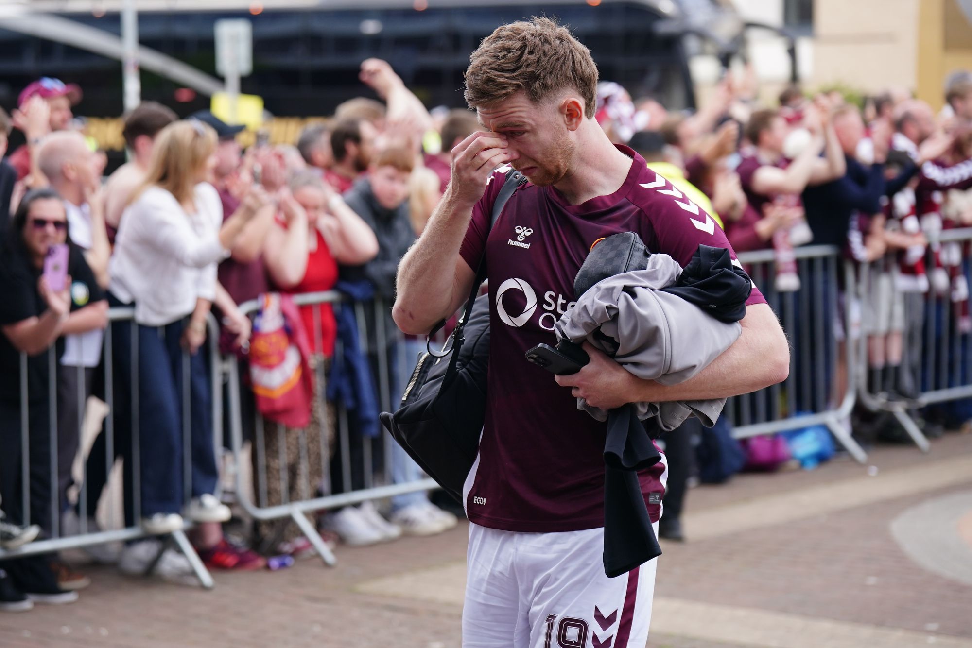 Heart of Midlothian player Stuart Findlay becomes emotional as he walks past fans